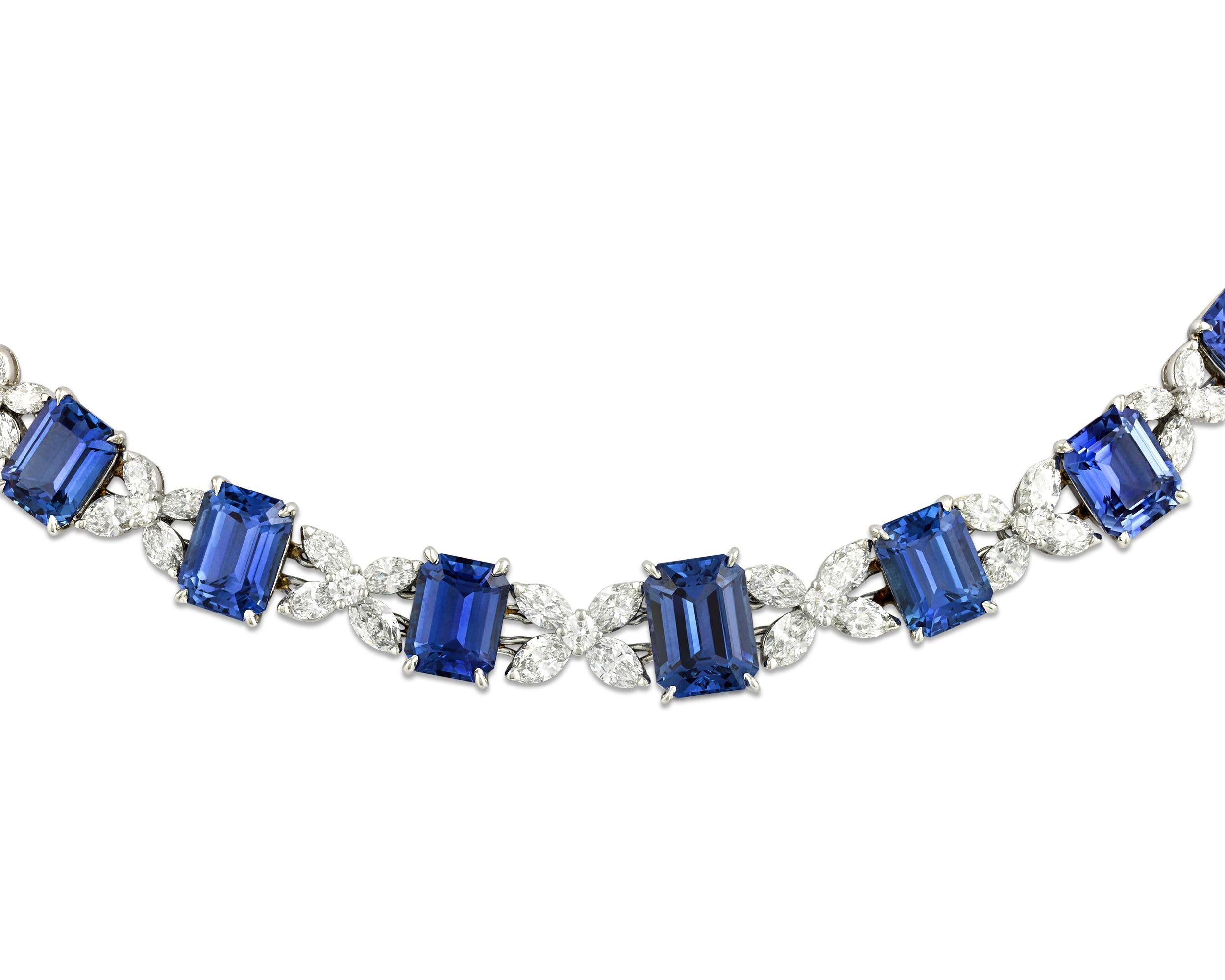 This breathtaking necklace by legendary jewelry designer Oscar Heyman features 26 emerald cut sapphires totaling 85.21 carats. Dotted between the blue gemstones are both marquise and round cut white diamonds in a striking criss-cross pattern and