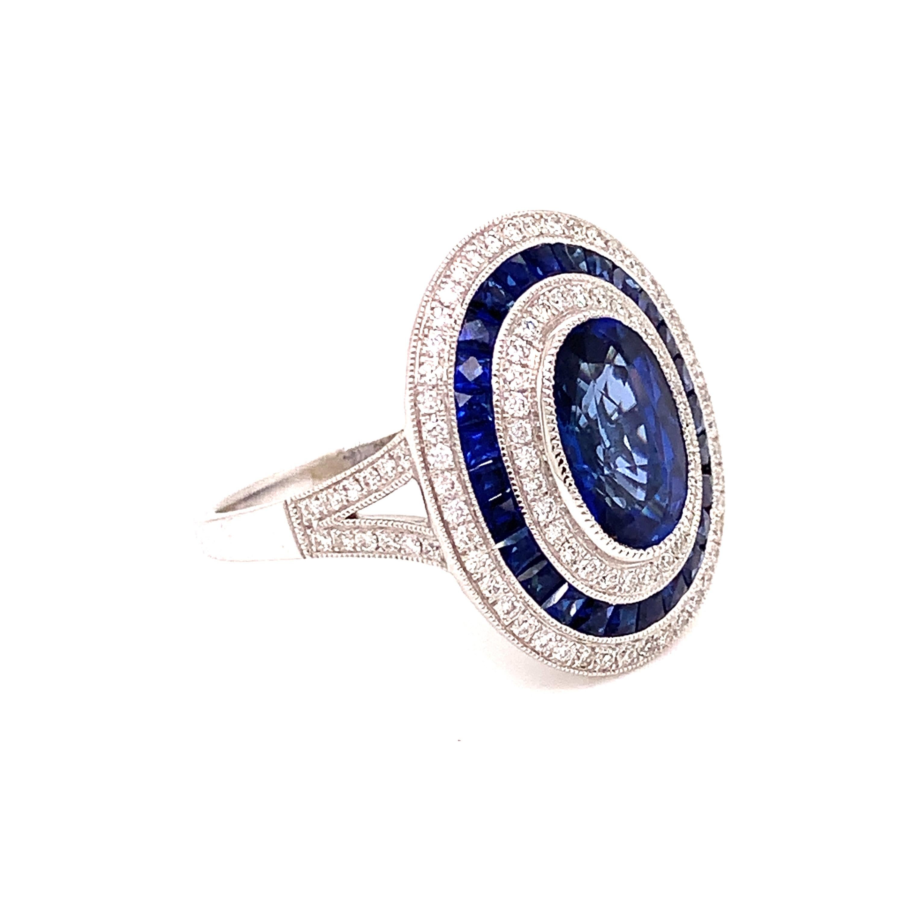 Old world craftsmanship with todays technology, this vintage art deco inspired ring may be even better than Grandmas.   A stunning 2.35 carat oval sapphire, surrounded by .37 cttw in round diamonds and .79 cttw in french cut ceylon sapphires.  4.27