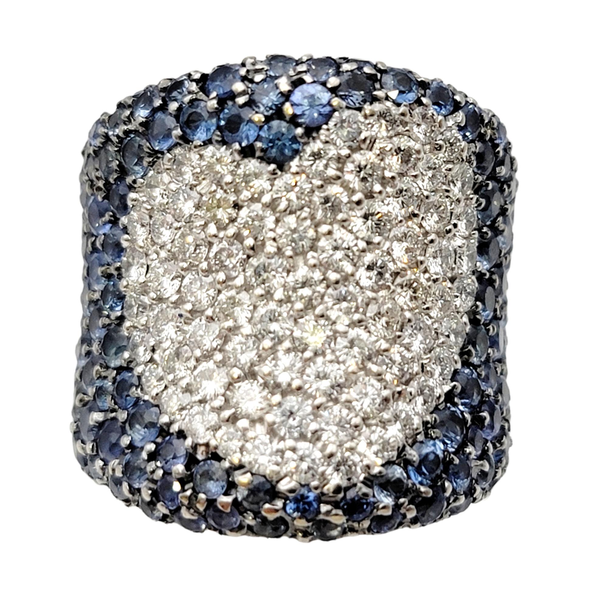 Ring size: 6.25

This is an absolutely sensational sapphire and diamond band ring that fills the finger with dazzling design. The ring is super sparkly, with a wide, sleek contoured design, making the natural stones shimmer and shine from all
