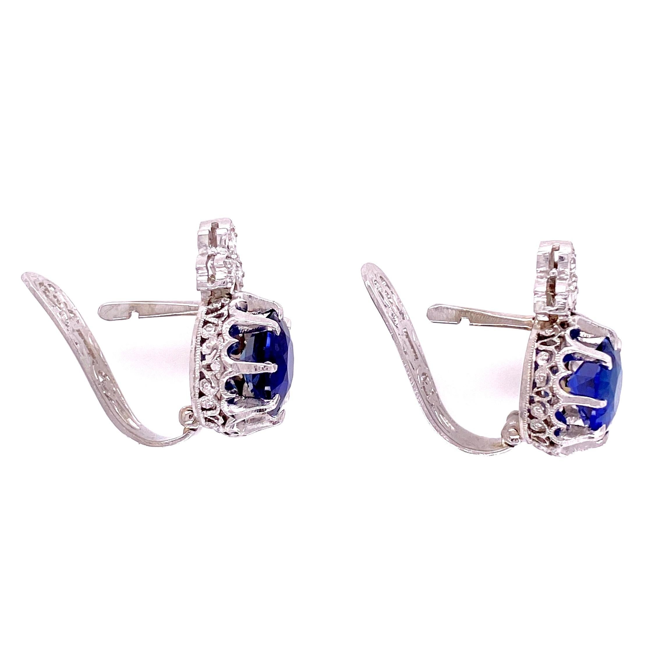 Simply Beautiful! Finely detailed Art Deco Revival Sapphire and Diamond Drop Earrings. Each center securely set with a Blue Sapphire; approx. total weight of the 2 Sapphires 3.64tcw, surrounded by Diamonds, approx. 0.20tcw. Hand crafted Platinum