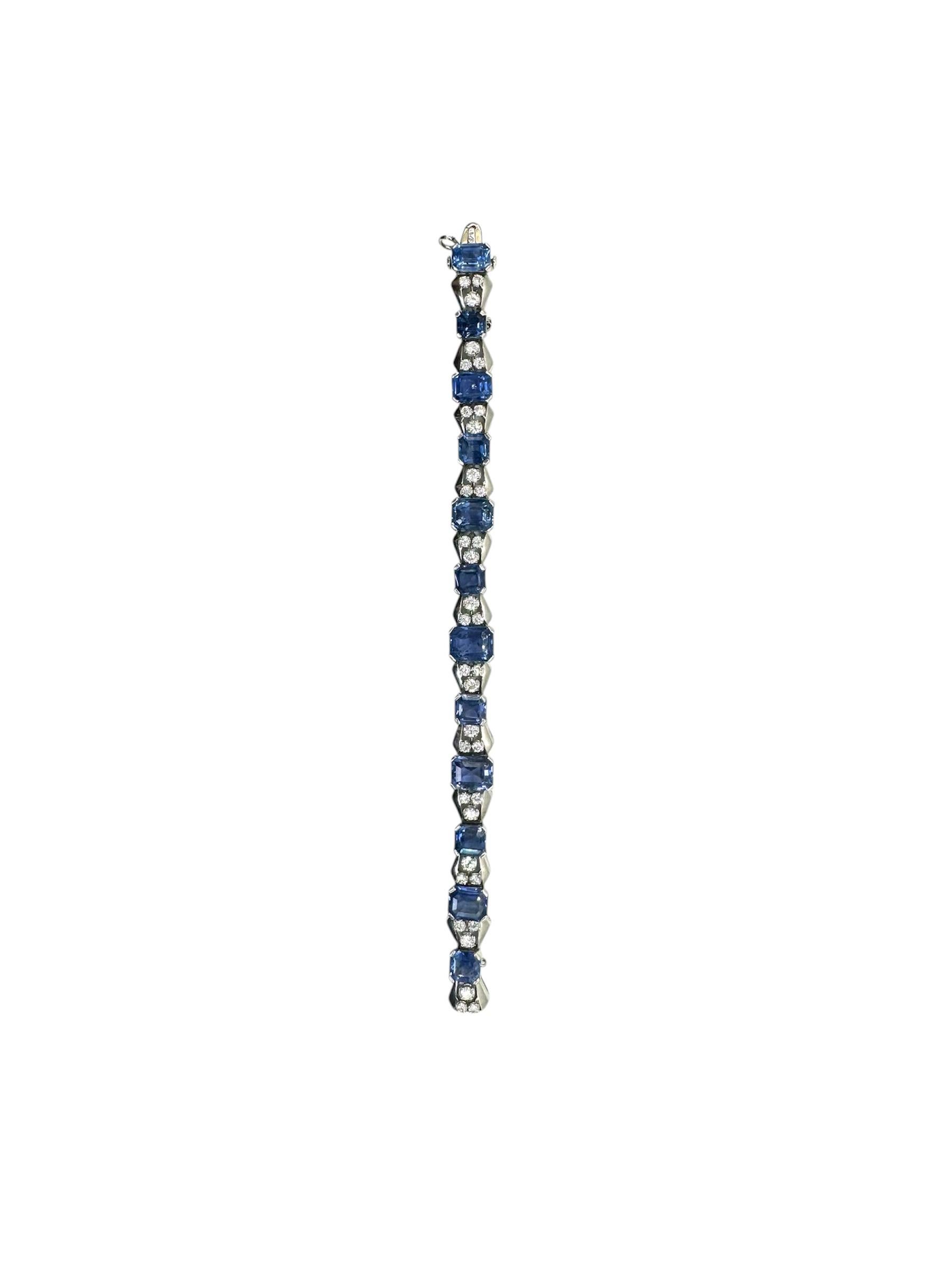 A SAPPHIRE AND DIAMOND BRACELET, BY OSCAR HEYMAN & BROTHERS
Composed of ten cut-cornered square-cut sapphires, each flanked on either side by a tapered square-cut sapphire, within an openwork platinum frame, joined by circular-cut diamond vertical