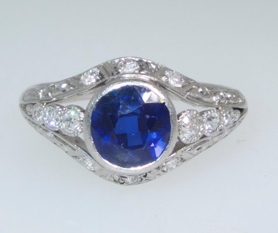 Diamond and natural Sapphire (probably Burma) ring centering a fine natural vivid blue sapphire weighing 1.35 cts., approximately and accented with white fine diamonds.  These diamonds weigh approximately .30 cts.  All of the diamonds are well cut