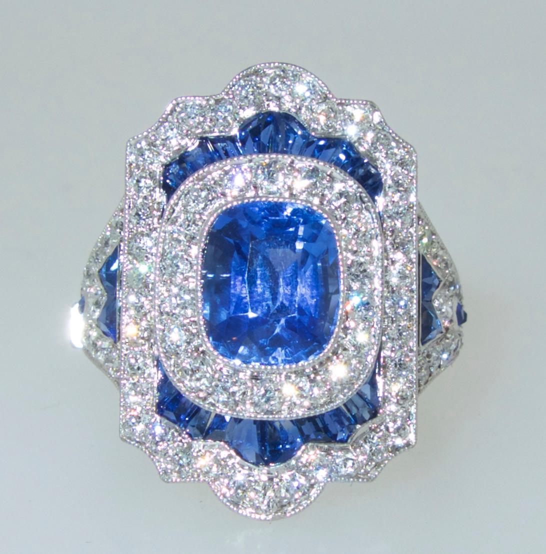Sapphire and diamond ring handmade in platinum with fancy cut fine natural sapphires, the center is a fine natural bright blue oval sapphire weighing approximately 2.55 cts.  There is another 1 ct. of fine fancy cut bright blue natural sapphires,