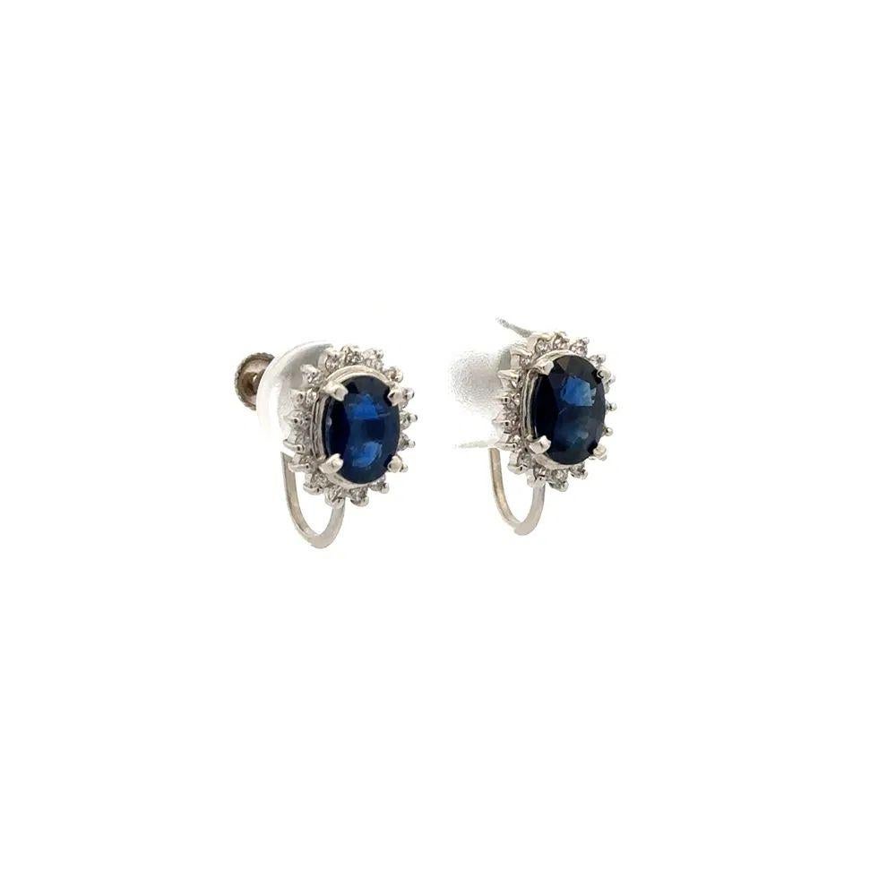 Simply Beautiful! Finely detailed Blue Sapphire and Diamond Platinum Vintage Stud Earrings. Each centering a securely nestled Hand set Oval Sapphire, weighing 2.00tcw. Surrounded by Round Brilliant Cut Diamonds, approx. 0.30tcw. Measuring approx.