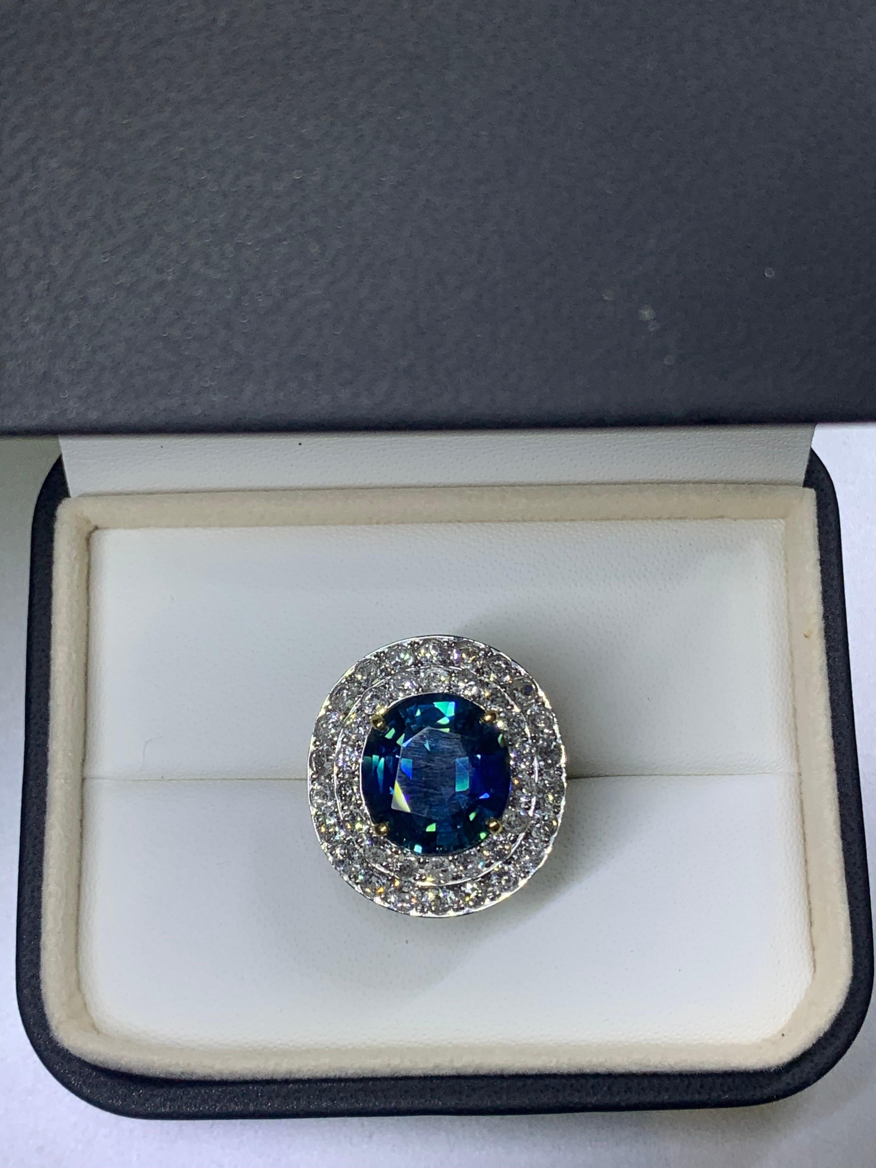 Sapphire and halo diamond in 18k yellow gold 
Sapphire weight 9.50ct  
Diamond weight 2.00ct F/G VS
Measurements 2.5x2.3mm
18k yellow gold 
Box and valuation included