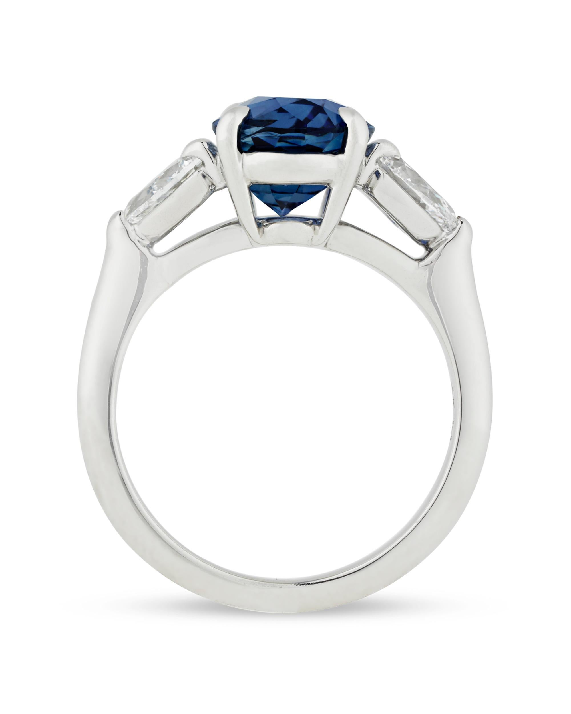 A regal, royal-blue sapphire is at the heart of this timeless ring. Weighing 3.90 carats, this elegant jewel possesses even color distribution and rich saturation, characteristics of high-quality colored gemstones. White diamonds totaling 0.78