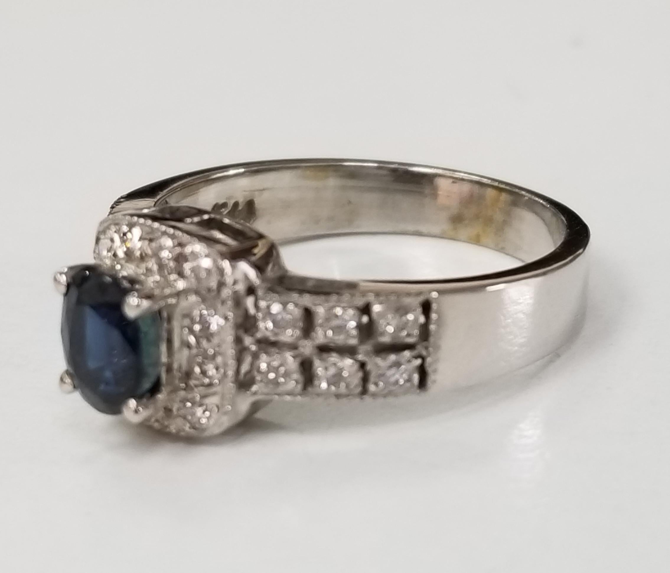 14k white gold sapphire and diamond ring containing 1 oval sapphire weighing .80pts. and 26 round full cut diamonds weighing .25pts.  This ring is a size 6 but we will size to fit for free.
