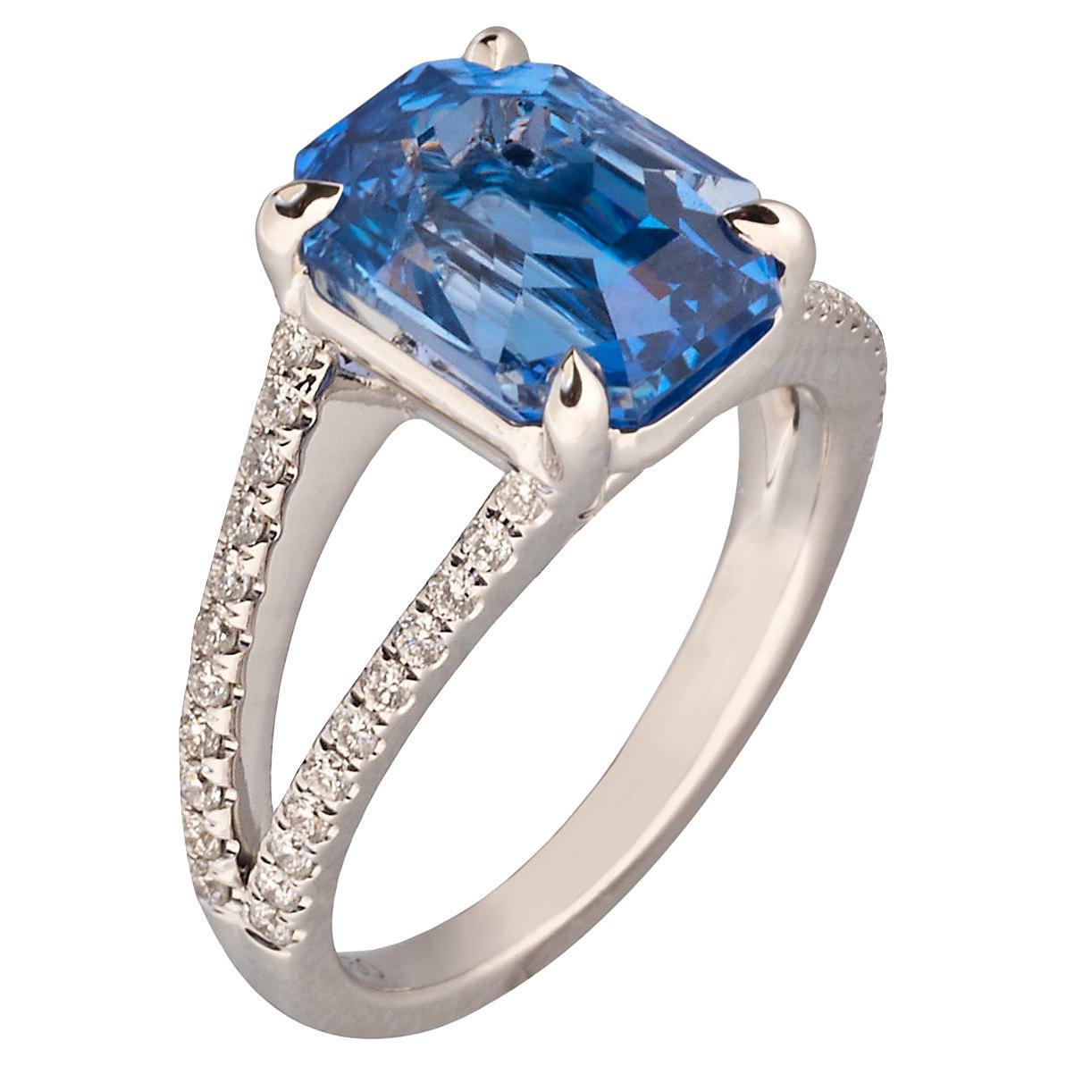 Centering on a rectangular emerald-cut sapphire of 5.29 carats with 44 round diamonds embellishing the 18K white gold shank. 

Size 5-1/4, can be resized   
2021 AGL report no. 1116075, of Ceylon origin, no gemological evidence of heat, no clarity
