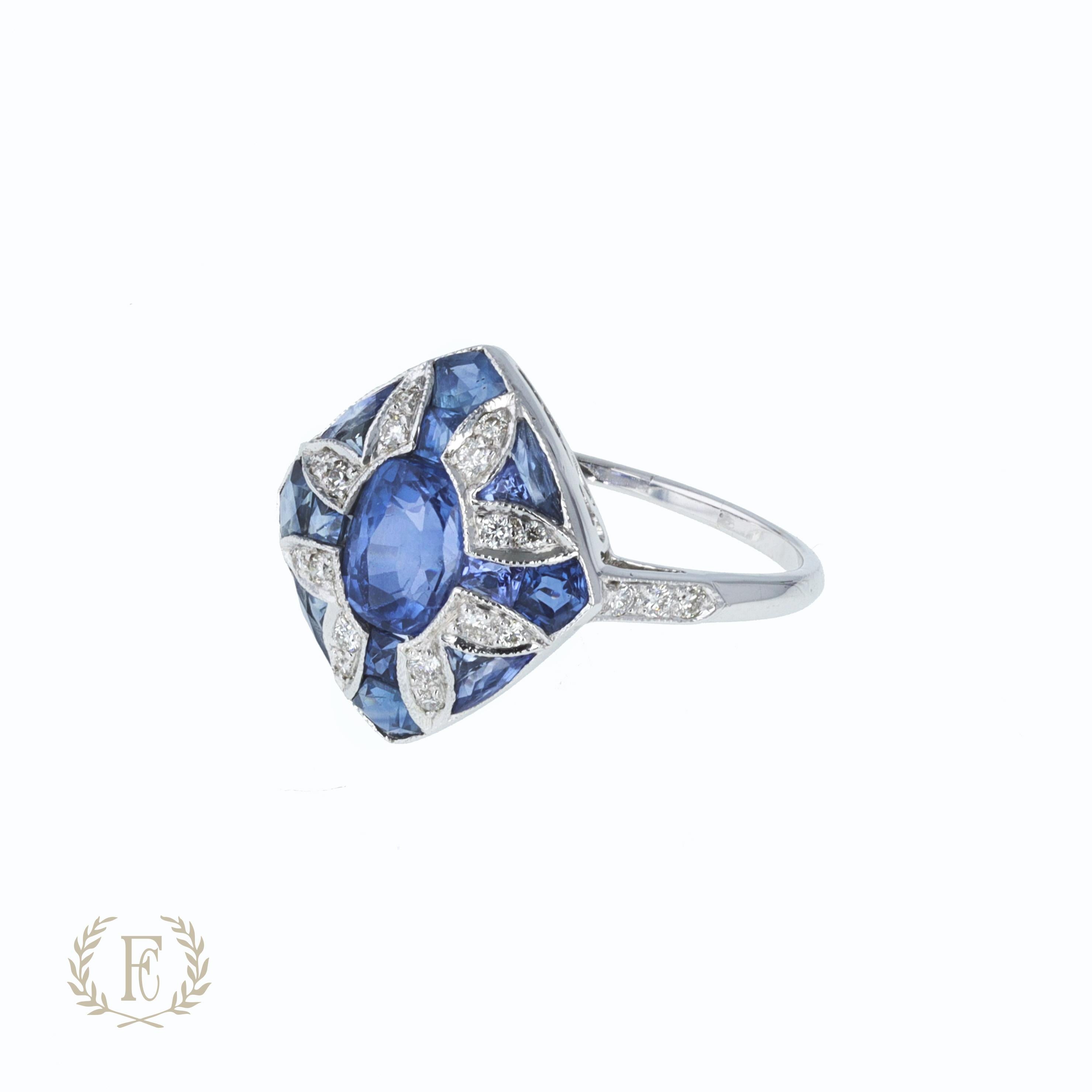 One platinum aquamarine and diamond ring containing one cushion aquamarine weighing 2.18 ctw, 6 baguette diamonds weighing 0.18 ctw, and 4 cabochon blue sapphires, sized to 4.25.