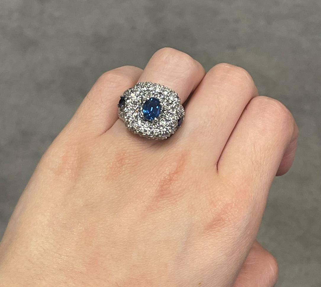 Sapphire and Diamond Ring

A white gold ring set with 3 oval sapphire accented by a cluster of 90 round cut diamonds,
Approximate center Sapphire Weight: .95 carat 
Ring Size: 7 
Resizable free of charge
Metal Type: 18-karat gold