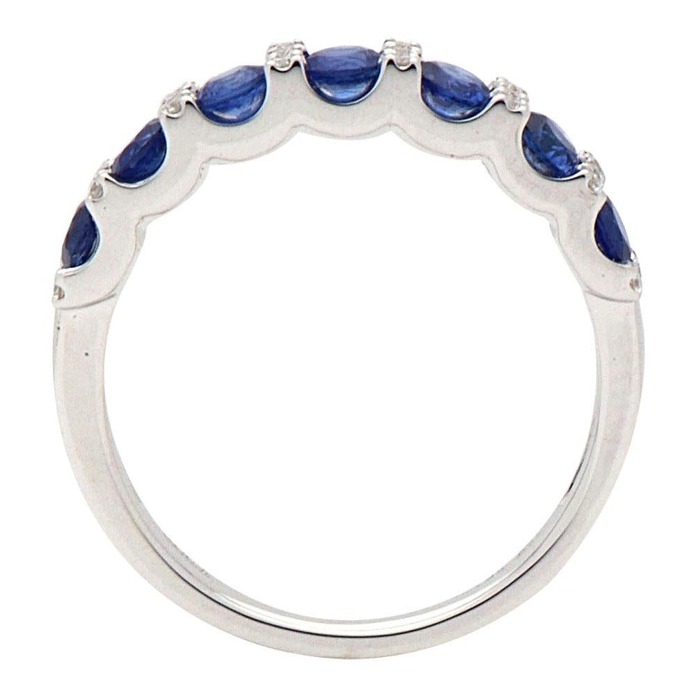This sapphire and diamond band has 7 royal blue sapphires totaling 0.80 carats which are separated by a column of VS2, G color diamonds. There are 24 round diamonds totaling 0.09 carats and they are set in 2.6 grams of 18 karat white gold. This ring