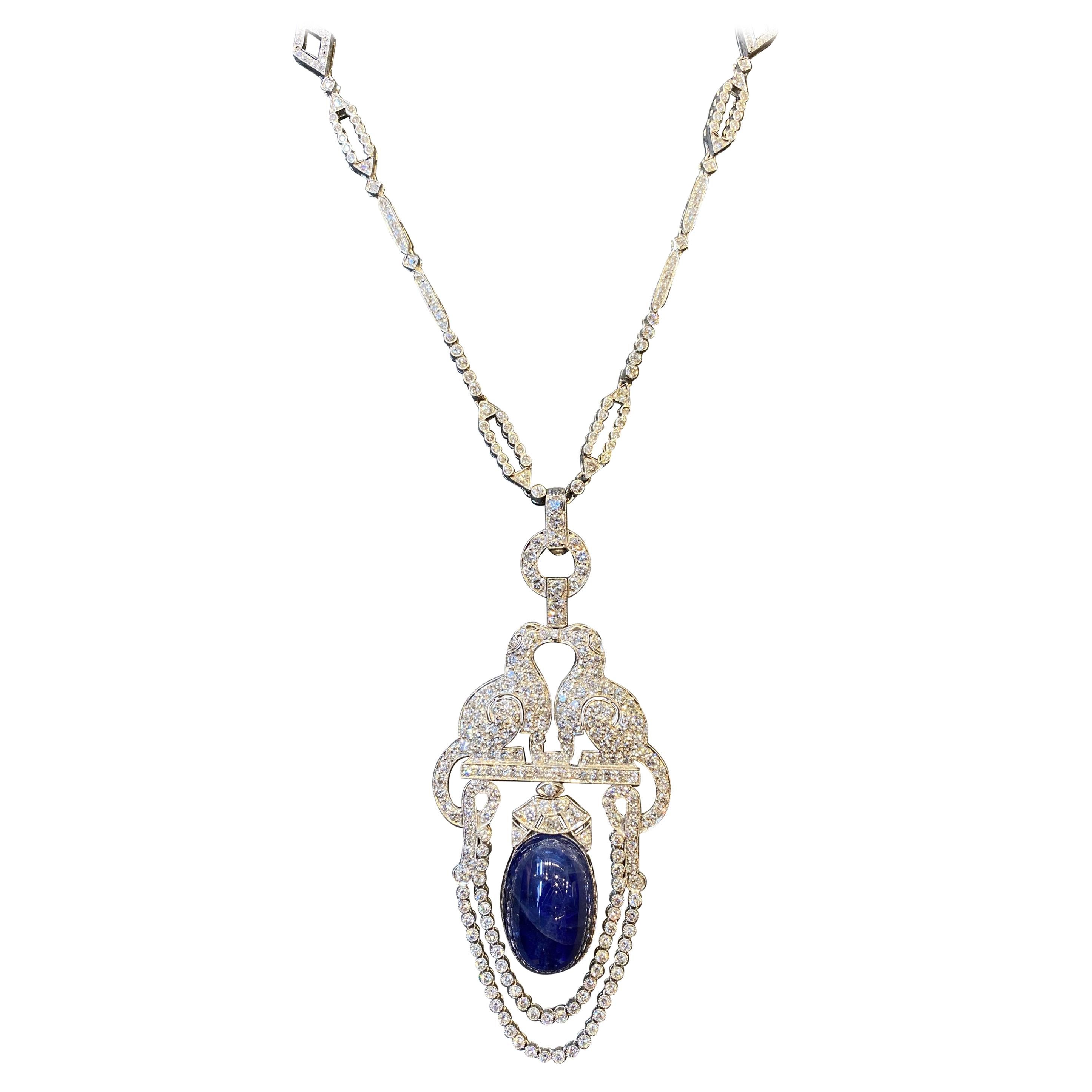 Sapphire & Diamond Sautoir Necklace
1 large cabochon sapphire weighing approximately 34.30 carats
Approximately 8 carats of diamonds
Pendant has two stylized diamond dogs facing each other
Set in platinum & 18k white gold.
Chain Measurements: 18
