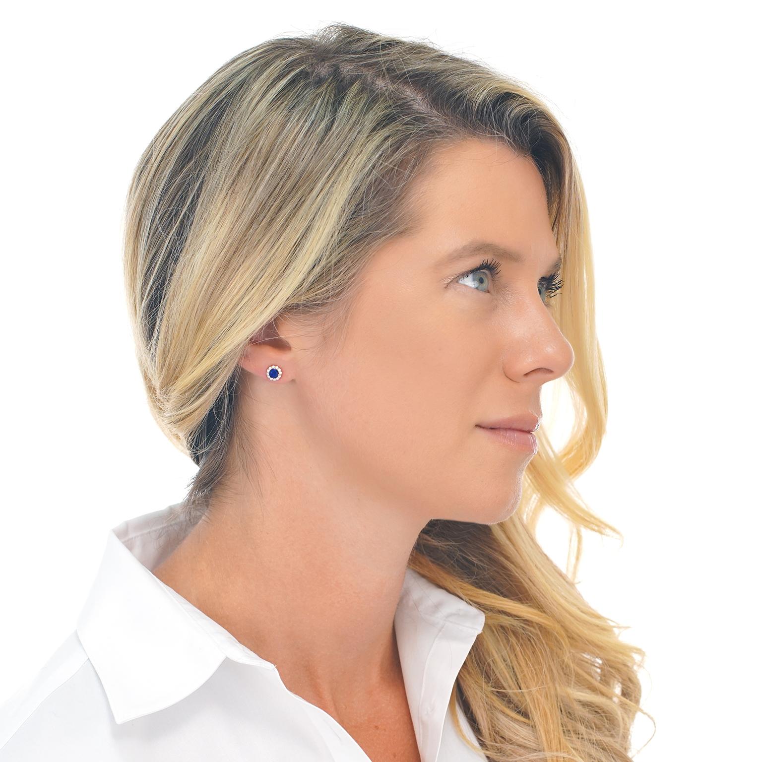 Circa 2000’s, 14k, American.  These earrings feature bright blue sapphires surrounded by brilliant diamonds set in rich rose gold. The perfect size for everyday wear, they effortlessly go with everything. Finely fabricated, this pair of earrings are