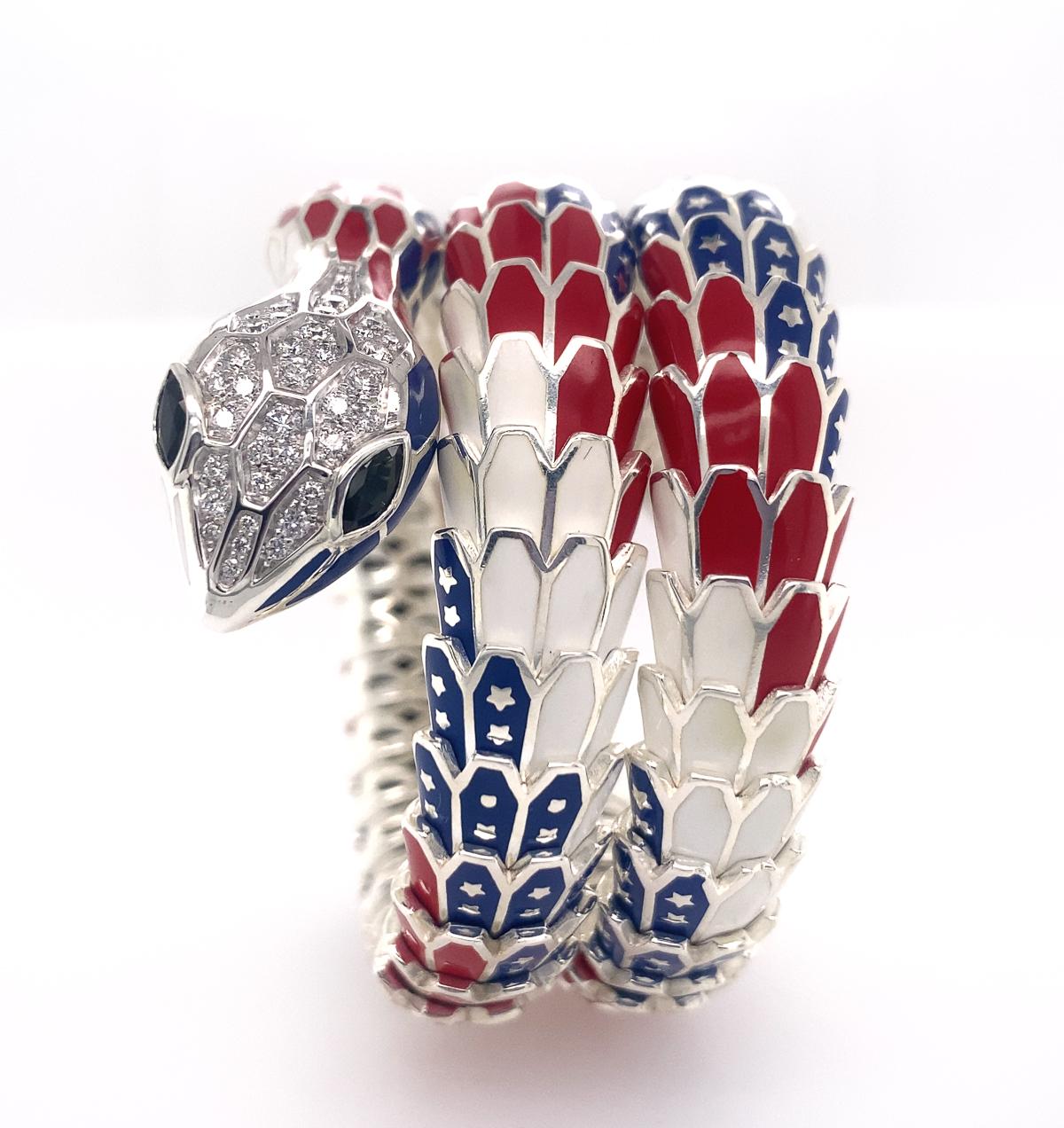 Very beautiful snake, the scales applied with blue, red, and white enamel which symbolizes American flag, the eyes set with marquise-shaped sapphires, further enhanced with pavé-set round brilliant-cut diamonds approx. 1.10 cts and 0.55 cts of