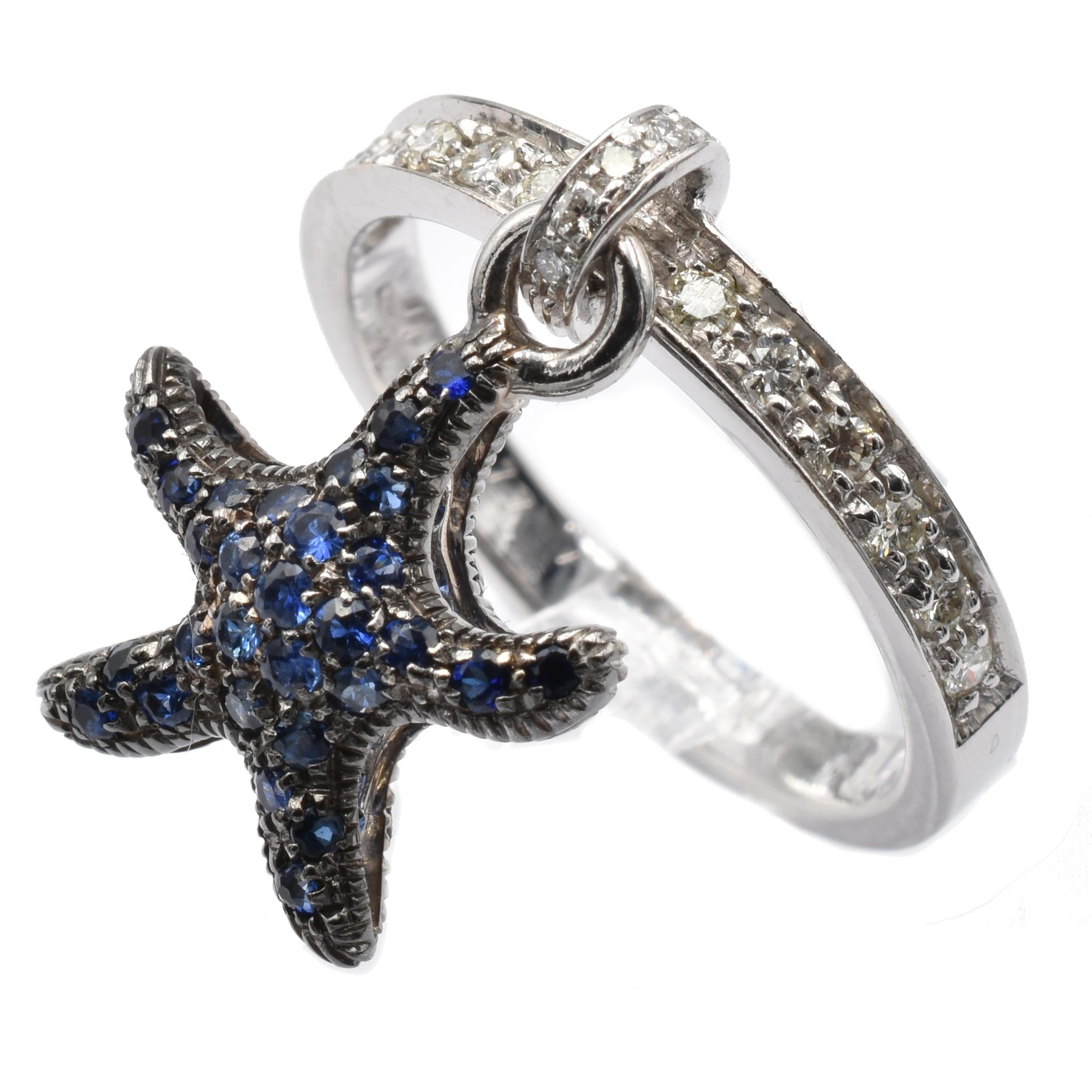 Gilberto Cassola 18Kt White Gold Ring with Pendant Starfish Charm. This Charm is set in both sides with Sapphires on Black Rhodium Gold and hangs freely on the ring.
A very Funny and Happy Piece that perfectly match with a Wedding Ring for an