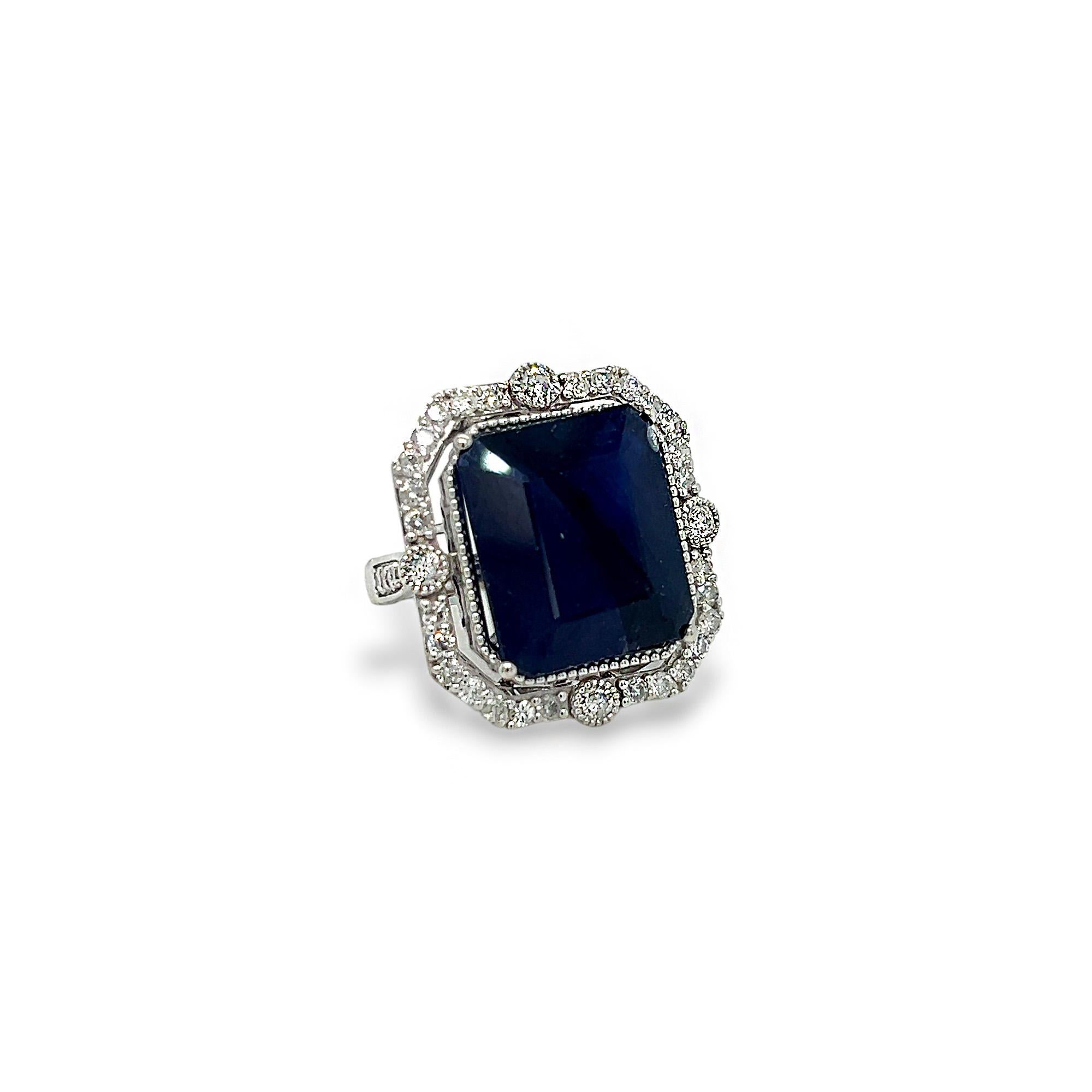 Questo splendido anello di rappresentanza presenta una bellissima pietra centrale di zaffiro taglio smeraldo da 22,70 carati, con diamanti laterali rotondi e una delicata finitura a grana fine. I diamanti laterali della fascia e quelli che