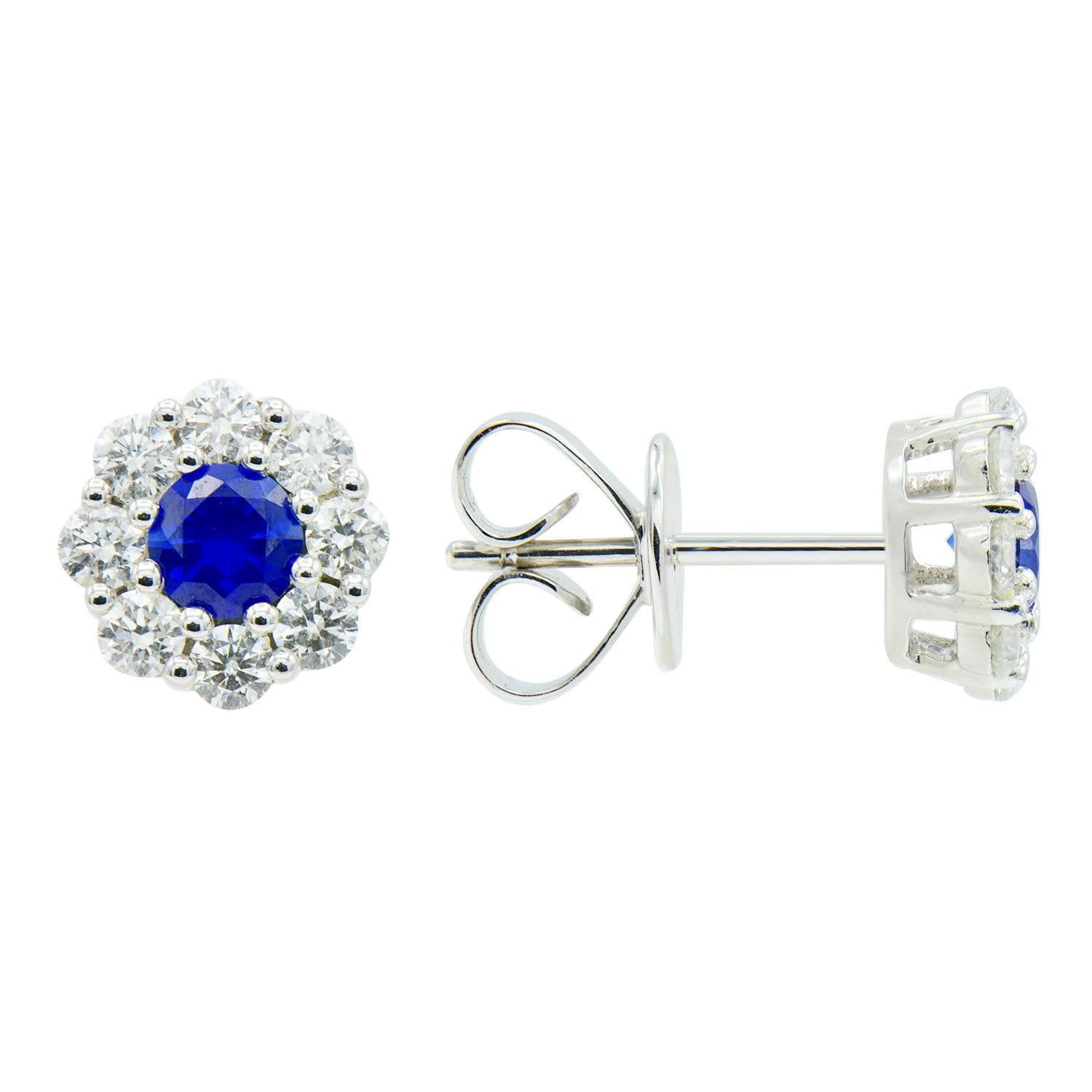 These stunning earrings are a classic staple to every jewelry collection. Each earring has a 0.23 carat sapphire in the middle surrounded by 8 shining diamonds. There is a total of 0.46 carats of sapphires and 0.55 carats of diamonds. These earrings
