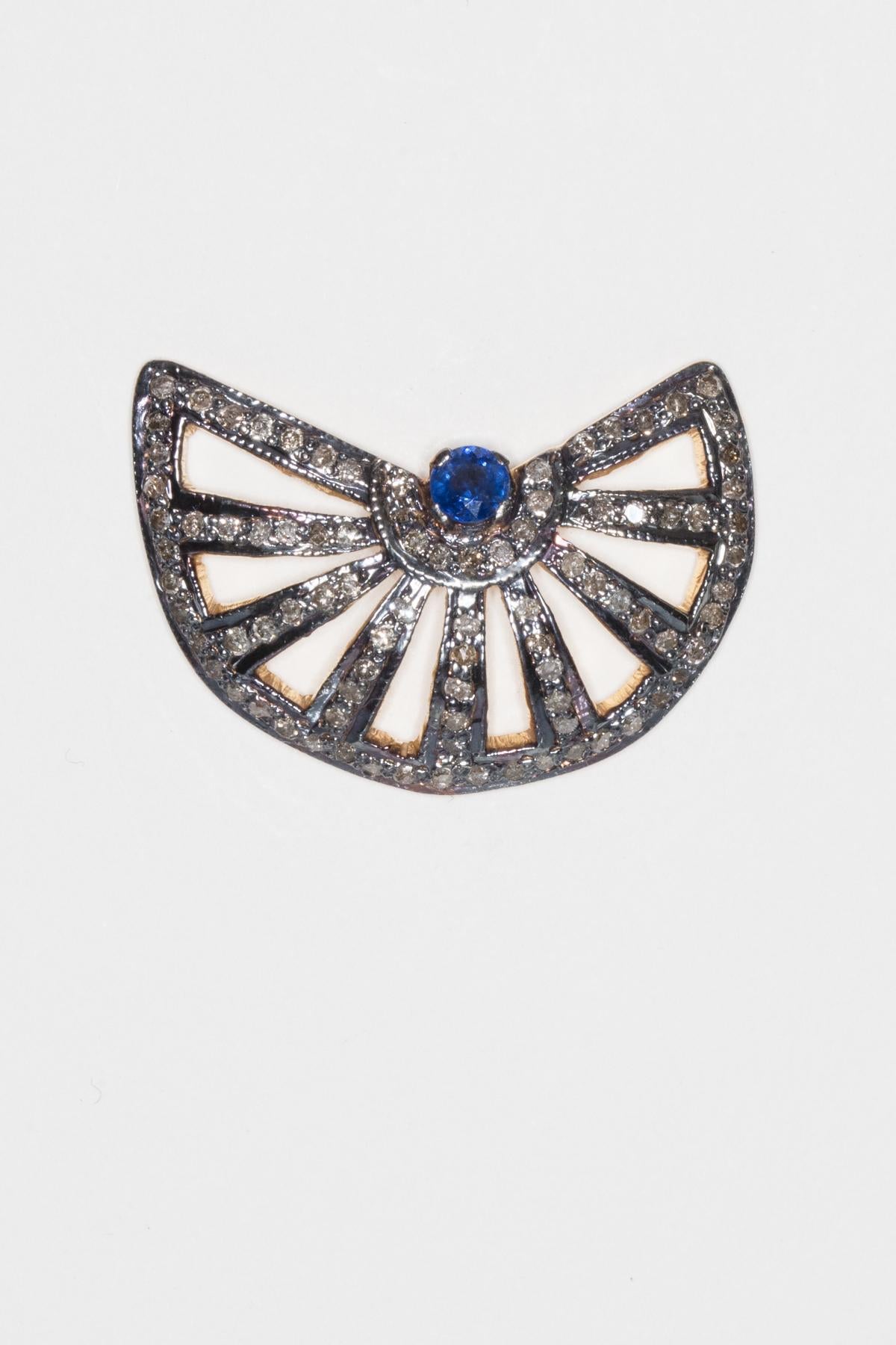 Faceted blue sapphire at center of fan-shaped stud earrings with pave`-set diamonds.  Set in oxidized sterling silver with 18K gold post for pierced ears.  Sapphires are .87 carats, diamonds are 1.71 carats.