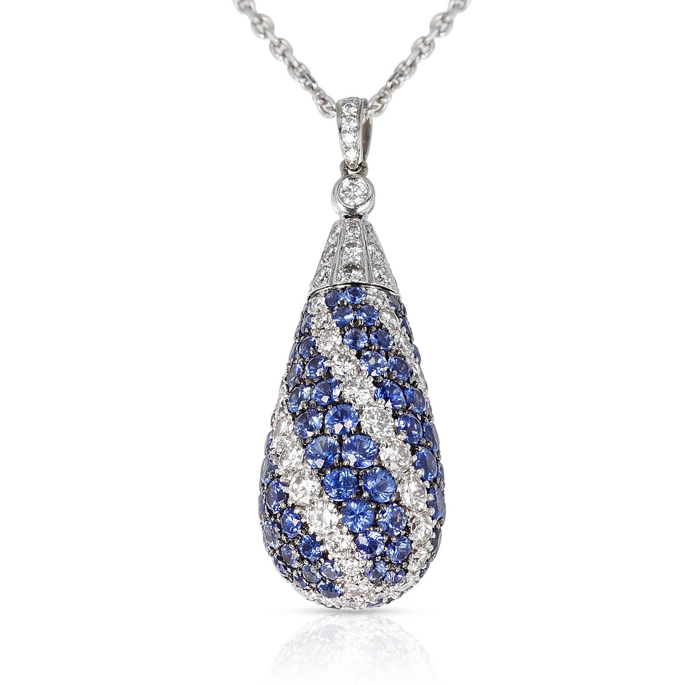 A beautiful Sapphire and Diamond Swirl Design Pendant Necklace made in 18k Gold with a chain. The total weight is 12.84 grams. The length of the pendant is 1.50.