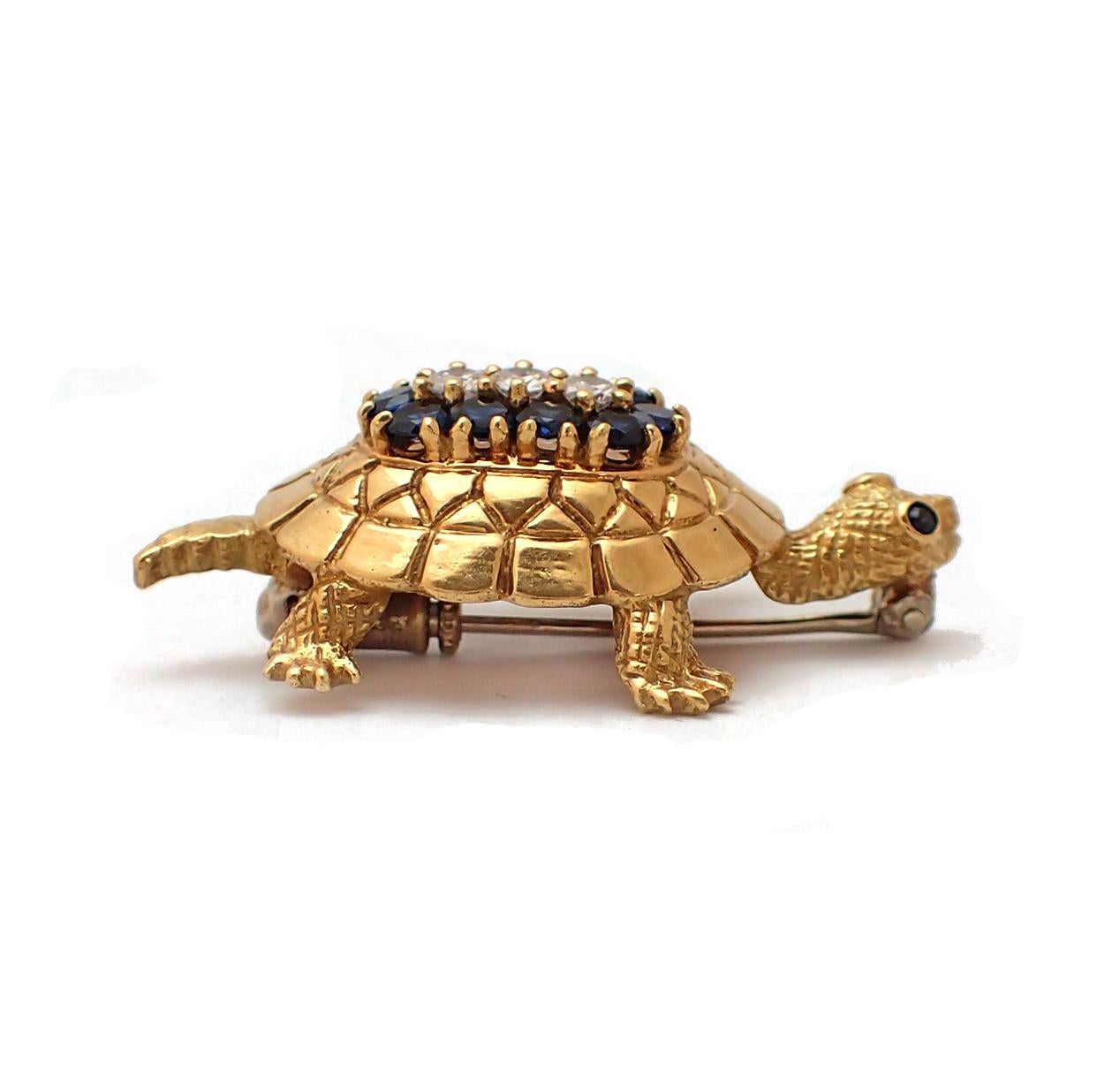 Add to your menagerie with this elegant turtle brooch. Consisting of about one carat of deep blue sapphires and approximately 3/4 of a carat if diamonds (G color, VS clarity), the turtle's shell has some great details. Additional sapphires are used