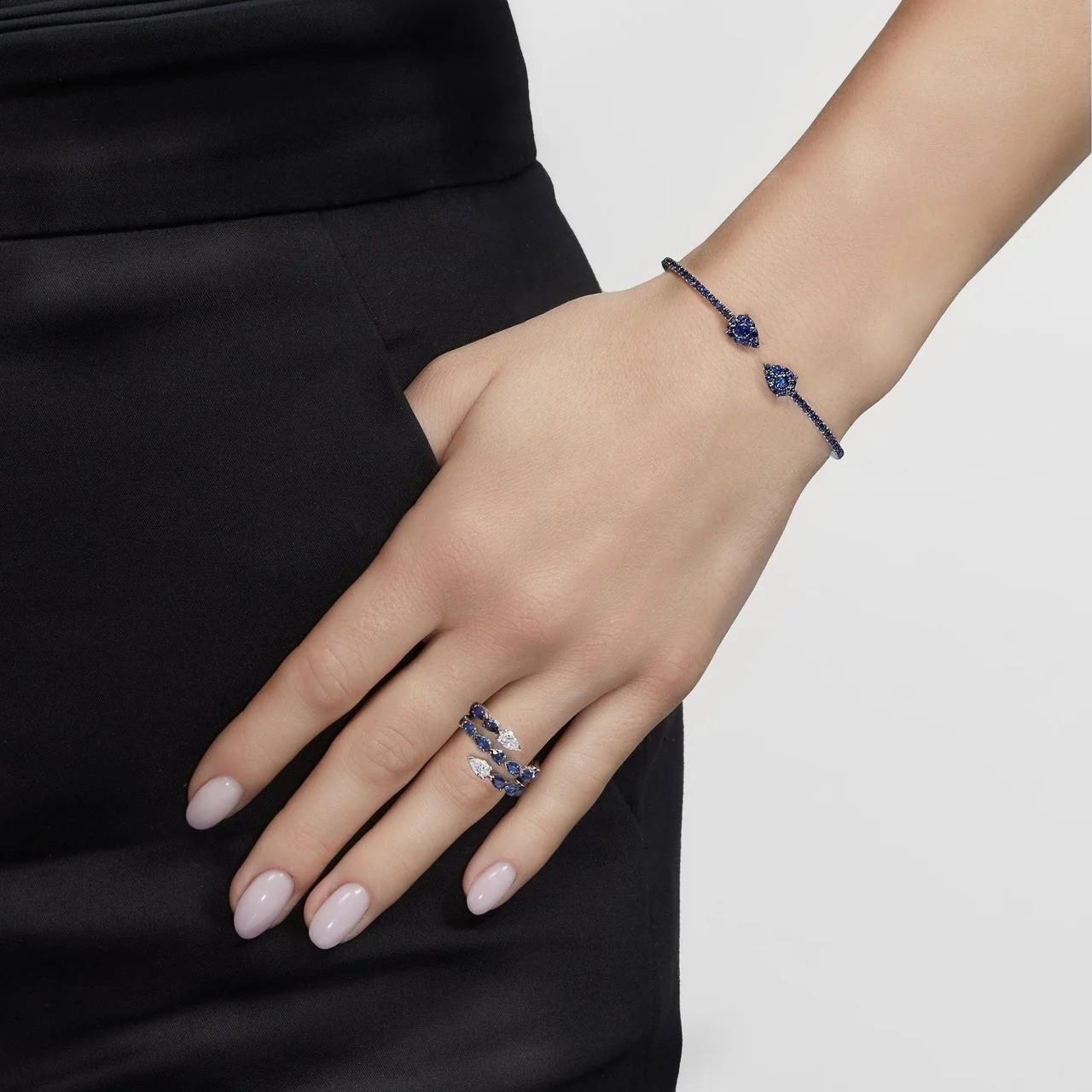 Three rows of shining gems comprise the breathtaking Sapphire and Diamond Twist Ring. Elegant pear-shaped blue sapphires contrast with classic white diamonds, all set in 18-karat white gold. Wear the ring with denim, heels and your favorite Hermés