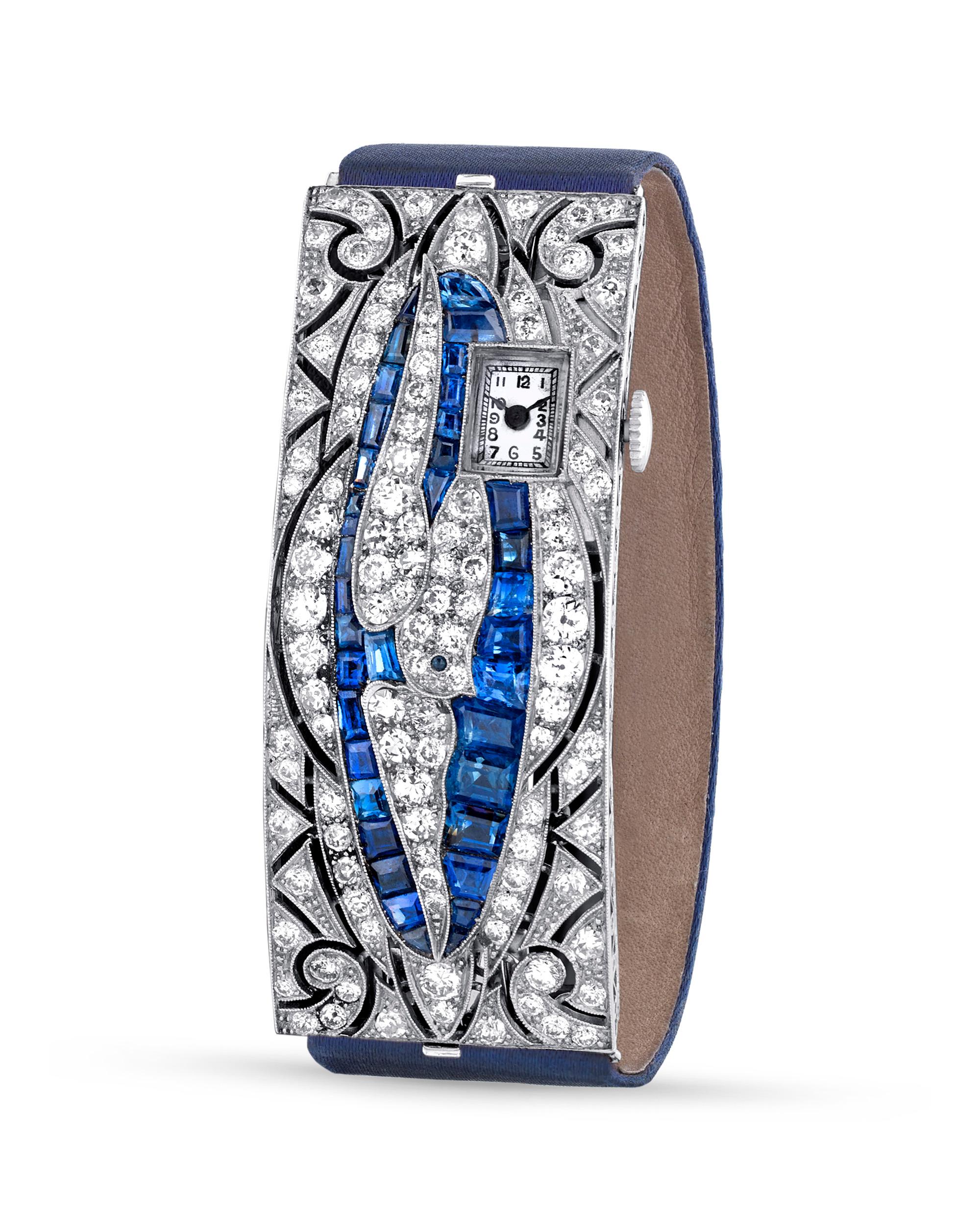 This remarkable Art Deco creation from the high-end Italian jeweler Bulgari is a truly exceptional timepiece. An array of old European-cut white diamonds and emerald-cut sapphires adorn the watch, which is crafted of platinum. Together, the