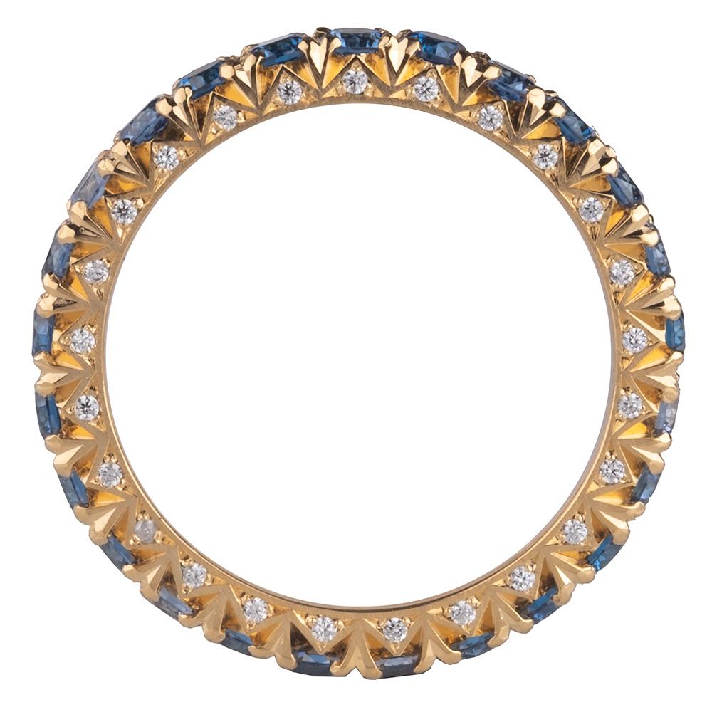 This men's sapphire and diamond French cut eternity band features 3 carats of Ceylon color sapphires and 0.25 carats of reclaimed diamonds in a 14 karat yellow gold band.
The diamonds and sapphires are expertly set and perfectly spaced which means