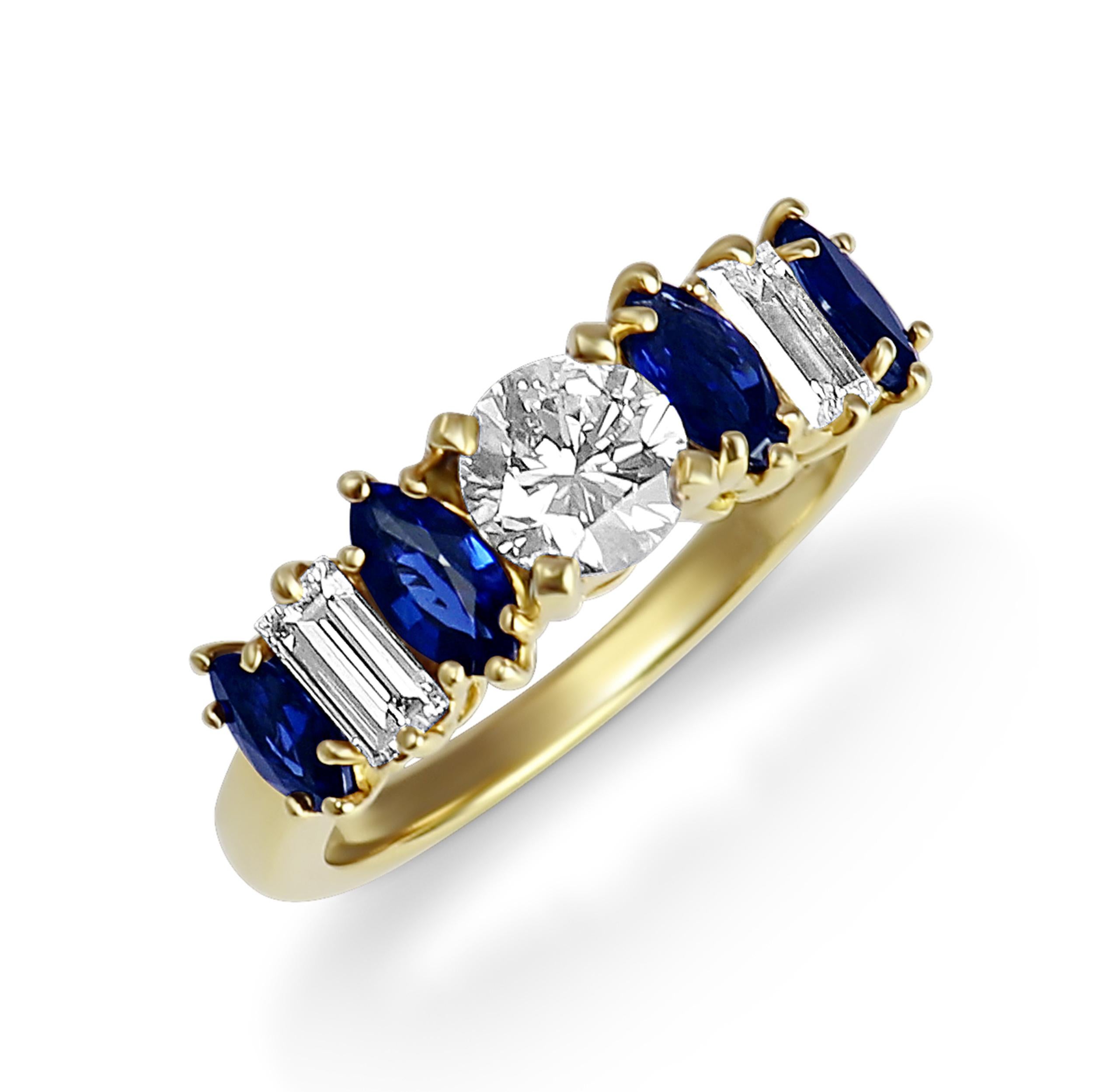 This 18 karat yellow gold ring features a 0.70-carat brilliant cut diamond as the center stone, accentuated by four marquise cut sapphires for a total weight of 1.07 carat and two baguette diamonds for a total of 0.50 carat. 
The ring is a size 6