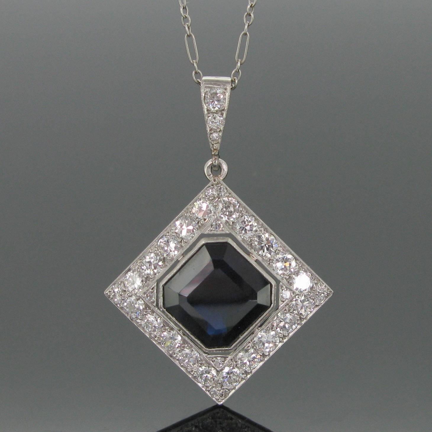 This beautiful pendant is set with a deep blue sapphire weighing approximately 8ct and framed with diamonds with an approximate total carat weight of 2ct. The bale and the clasp are also set with diamonds. The diamonds are set into a millegrain