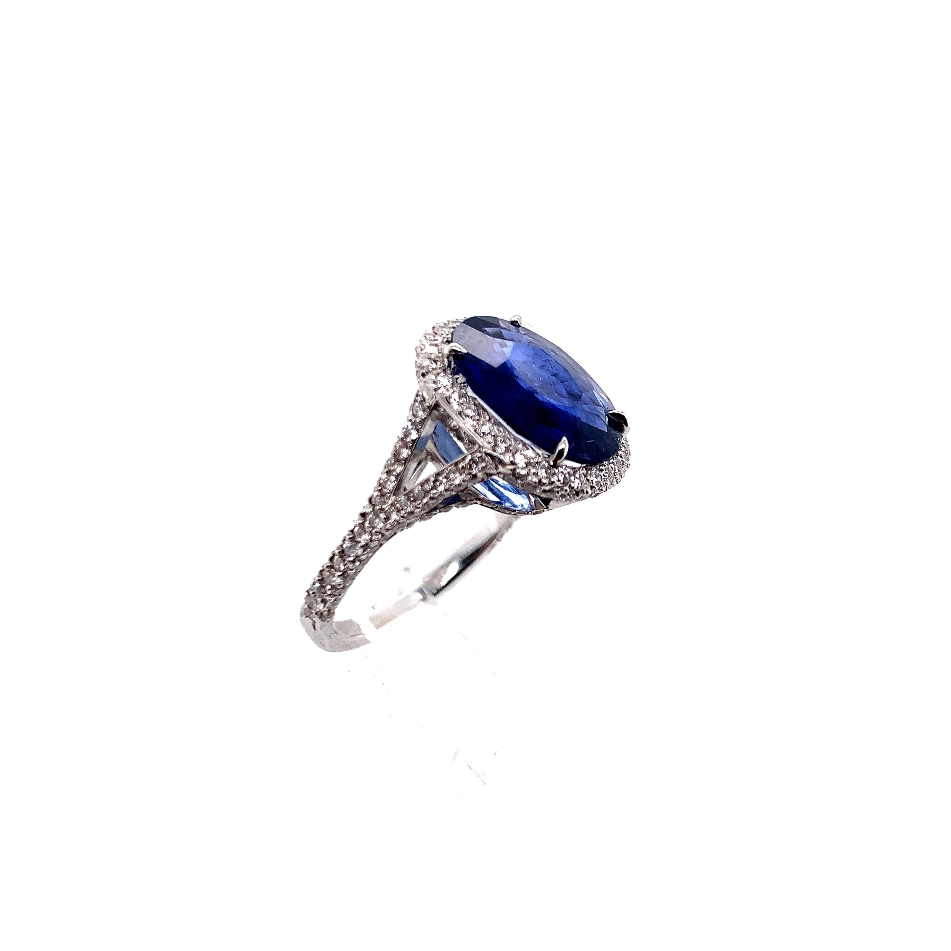 A beautiful 4.41 carat oval sapphire surrounded by approximately 1.5 carat round-cut diamonds in an 18k white gold. 