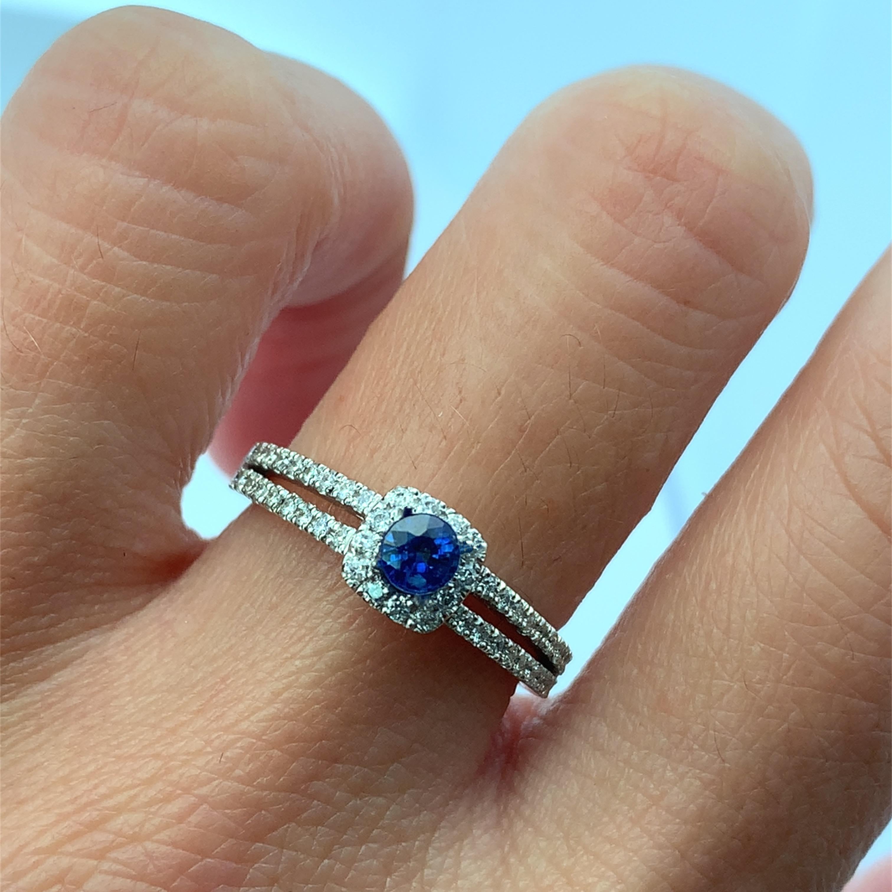 Discover the timeless beauty of this elegant  sapphire and diamond ring. Featuring a stunning central red round cut sapphire gemstone surrounded by a halo of sparkling diamonds, this piece is perfect for engagements or special occasions. Its