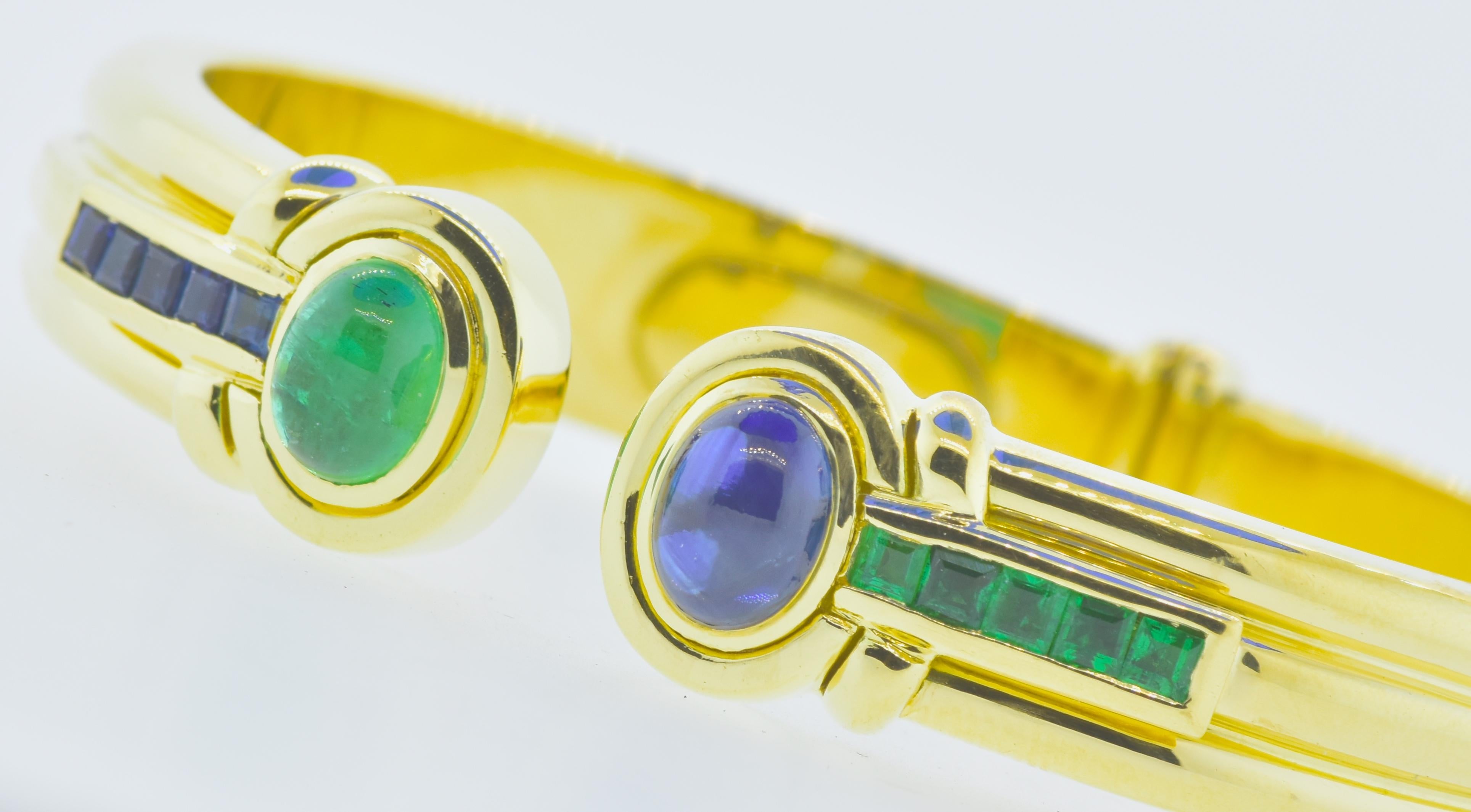 Emerald and sapphire 18K yellow gold European bracelet.  Of a size to fit most wrists and with the ability to open and close, this bracelet possesses fine natural sapphires and emeralds.  The bright blue cabochon sapphire weighs approximately 1.60