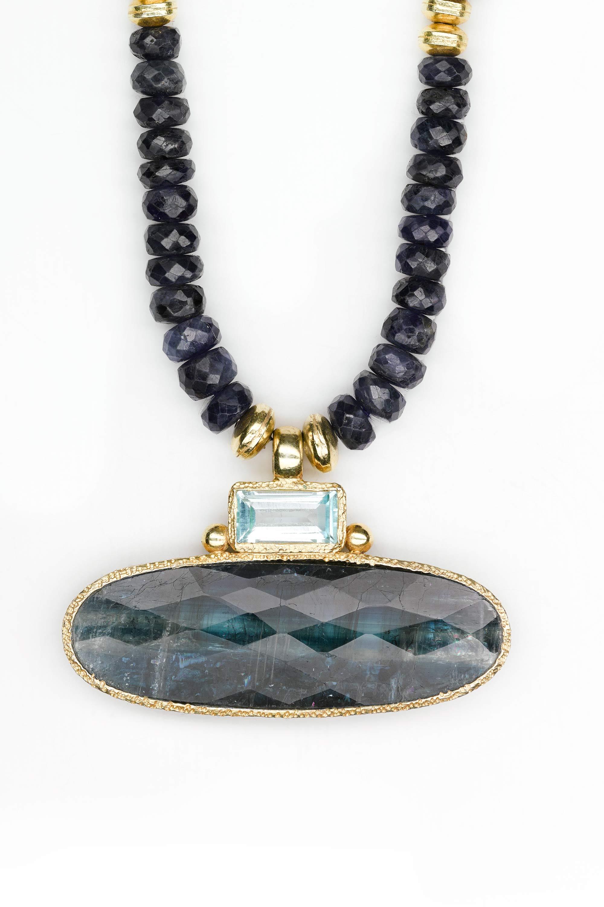 Sapphire and Kyanite 24 K gold vermeil pendant  with faceted sapphire bead necklace. 
Pendant measures 1.75 inches width. Sapphire beads dangle at back of neck when clasped.