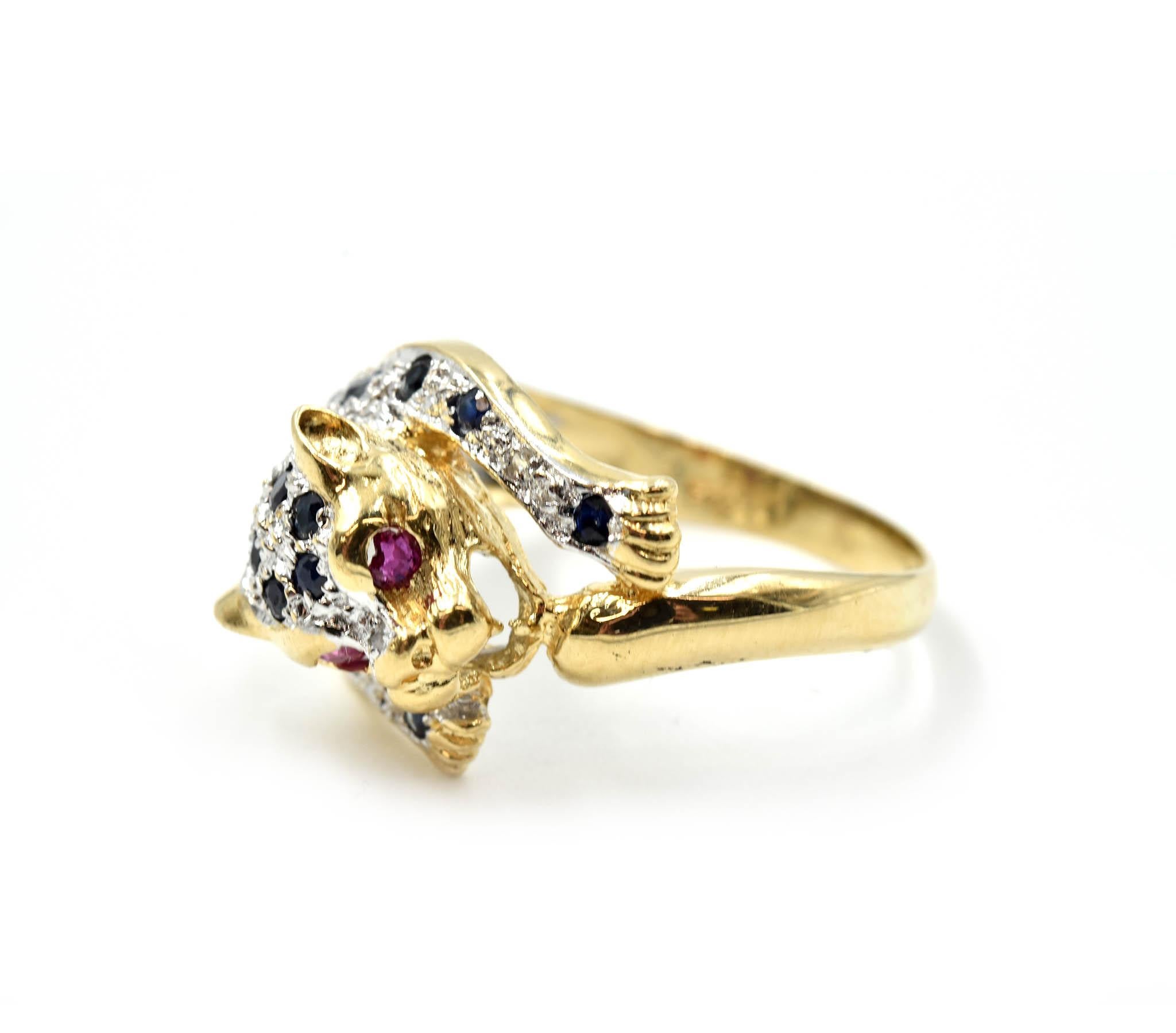 Designer: custom design
Material: 14k yellow gold
Sapphires: 22 round brilliant cuts = 0.44 carat total weight
Rubies: two rubies = 0.06 carat total weight
Dimensions: ring top is 1/2-inches long and 3/4-inches wide
Ring Size: 6 3/4 (please allow