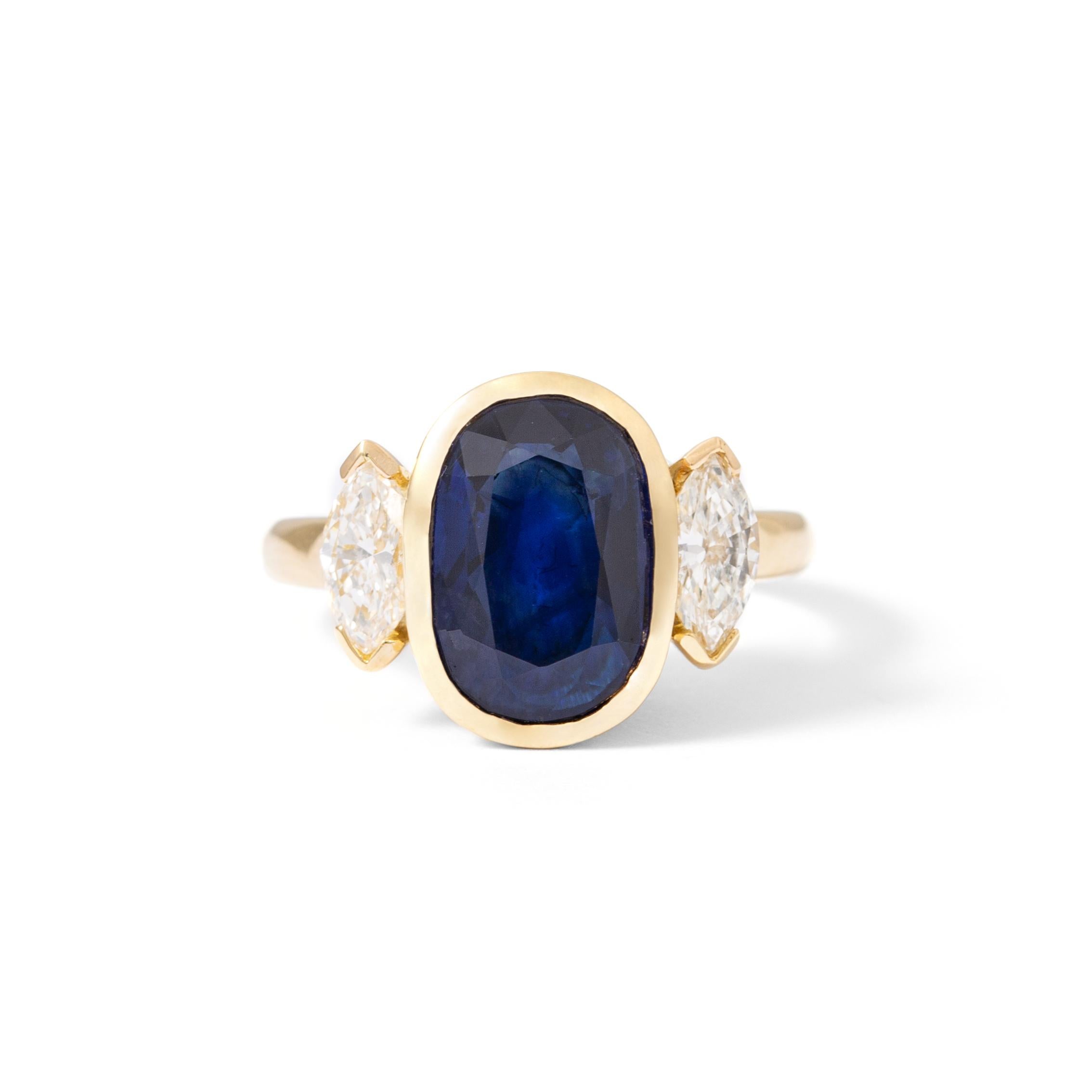 Ring in 18kt yellow gold set with one oval cut sapphire 3.30 cts and 2 marquise cut diamonds 0.70 cts Size 53   