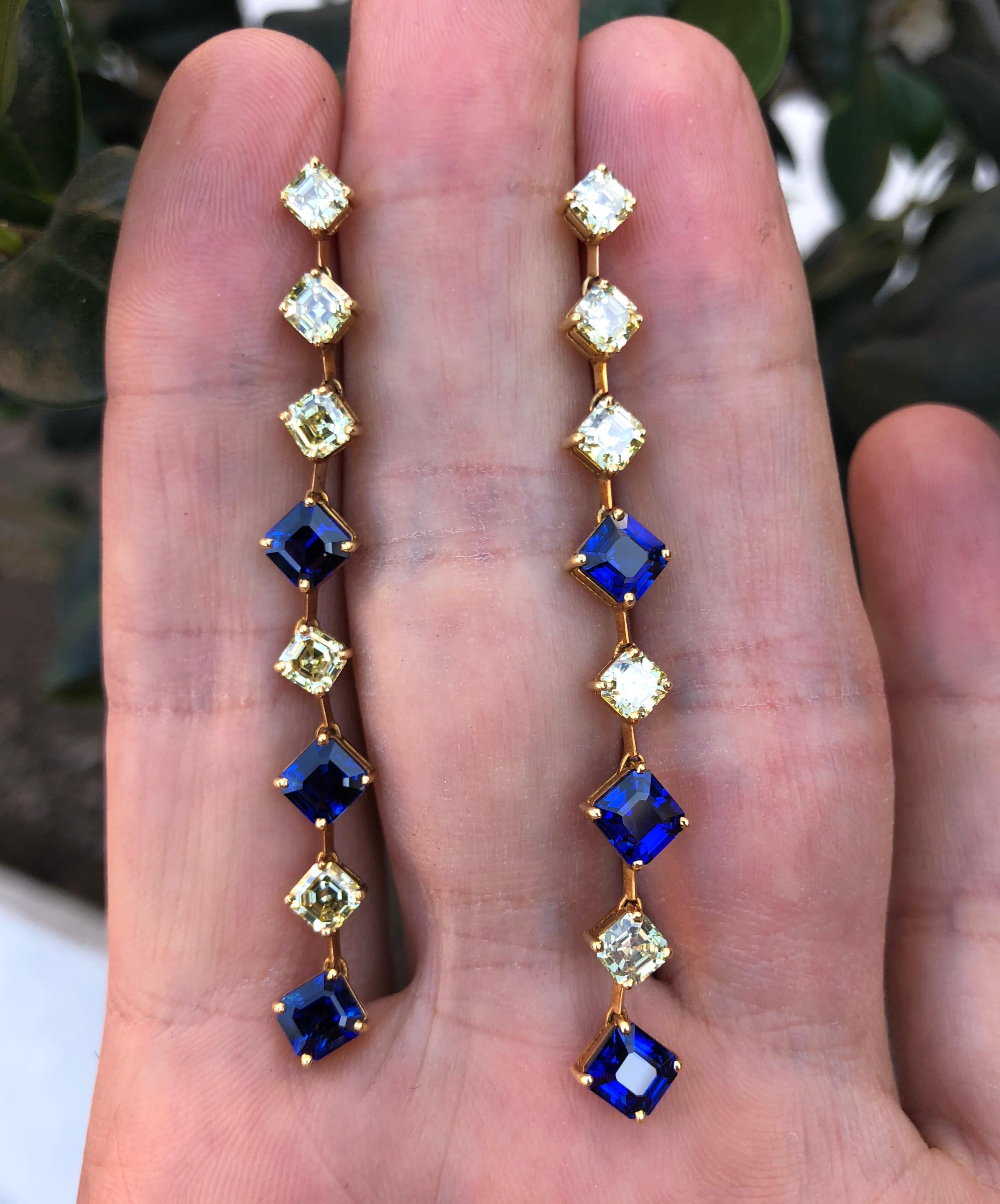5.14 carats of royal blue, square emerald-cut sapphires, and 3.38 carats of fancy yellow Asscher cut diamonds, are hand set in these very unique 18K yellow gold drop earrings.
Length: 2.5 inches. 