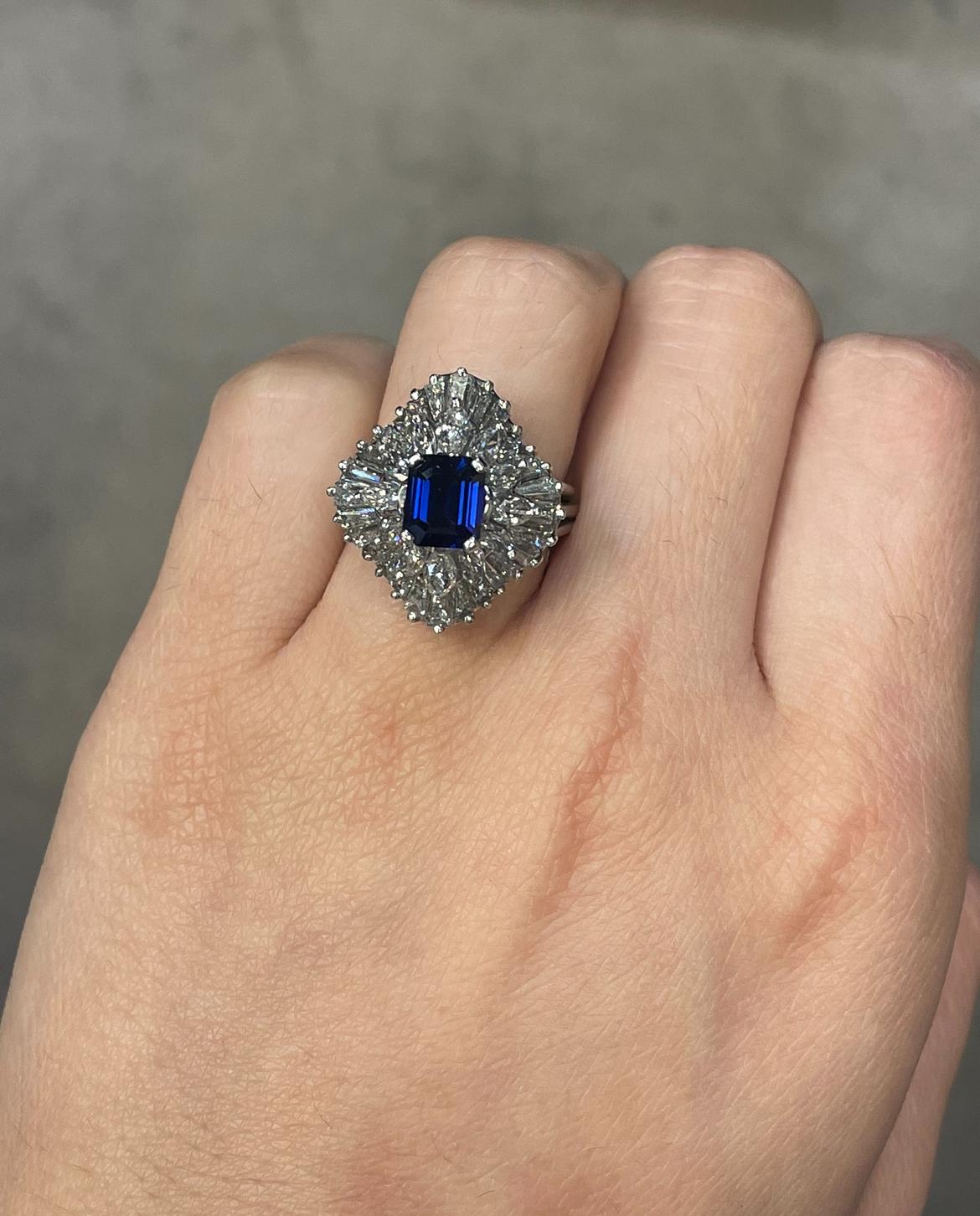 Sapphire Ballerina Ring 

A ballerina ring set with a center emerald cut sapphire, 12 marquise, and 28 baguette cut diamonds, 

Approximate Diamond Weight: 3.12 carats 
Ring Size: 6
Resizable free of charge
Metal Type: Platinum 
