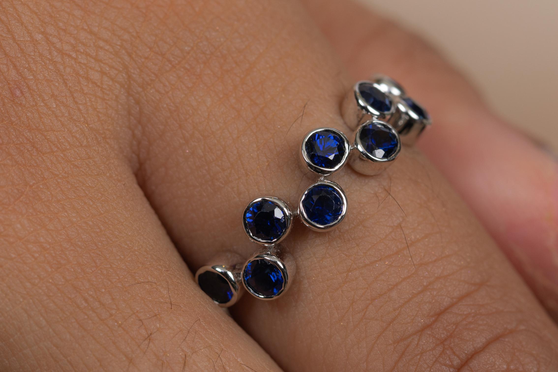 Blue Sapphire Half Eternity Band Ring in 18K gold symbolizes the everlasting love between a couple. It shows the infinite love you have for your partner. The circular shape represents love which will continue and makes your promises stay