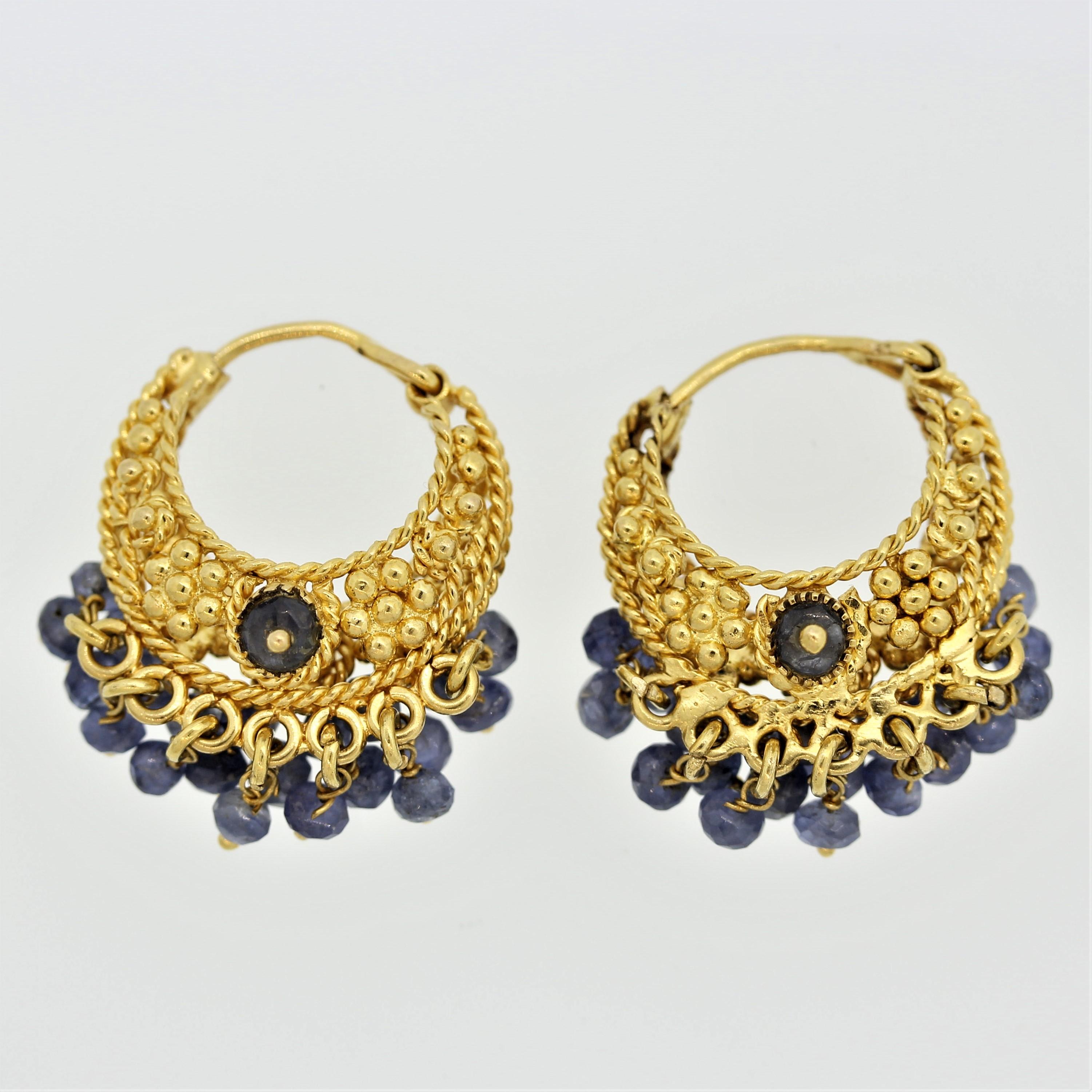 A unique pair of earrings which feature faceted beaded sapphires which are set as tassels on the bottom of the earrings. Made in 18k yellow gold with braids and round gold balls.

Length: 1 inch