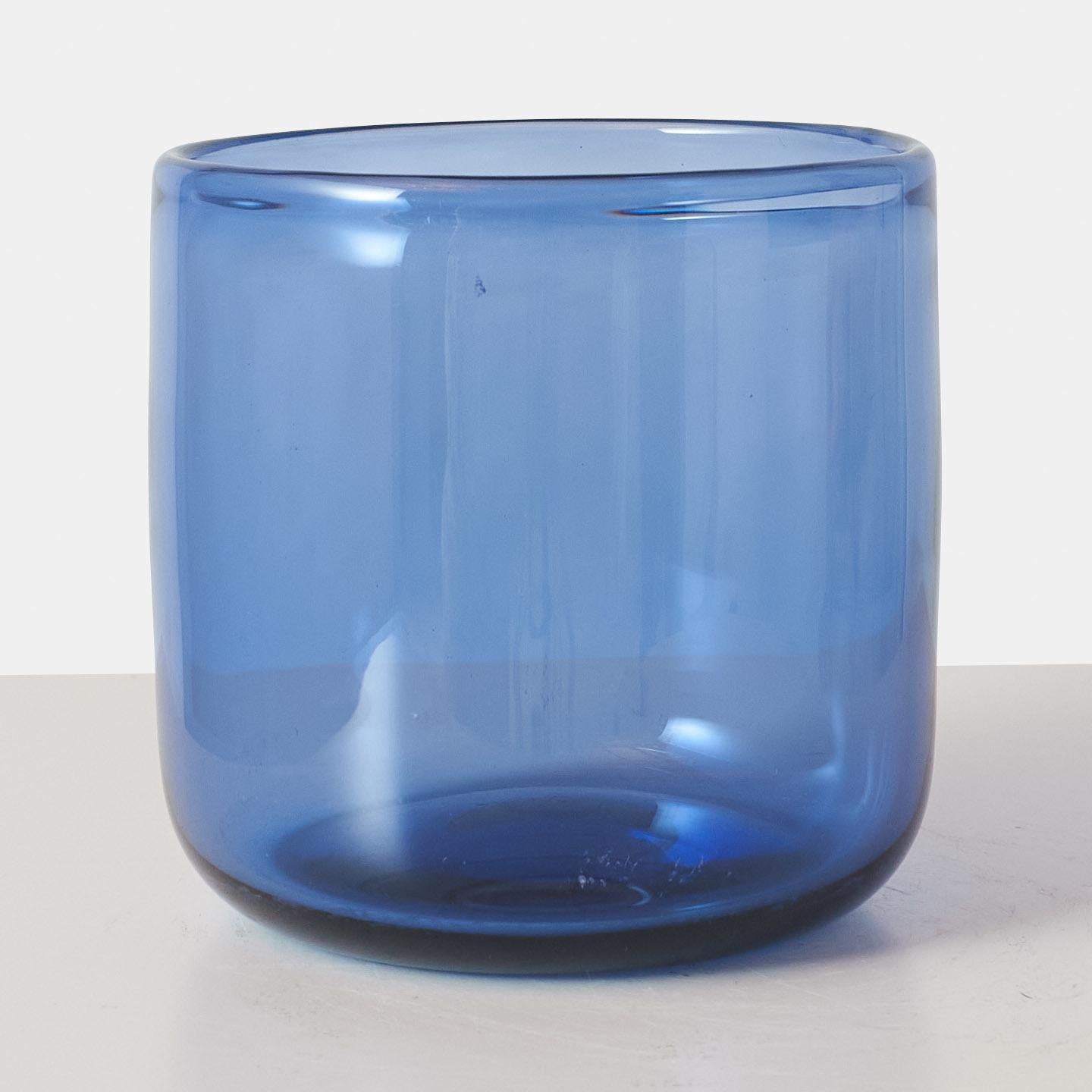 A sapphire blue high sided cylindrical vase by Per Lutken for Holmegaard. Some scuffing and light scratches, consistent with age and use. Not chips or cracks.