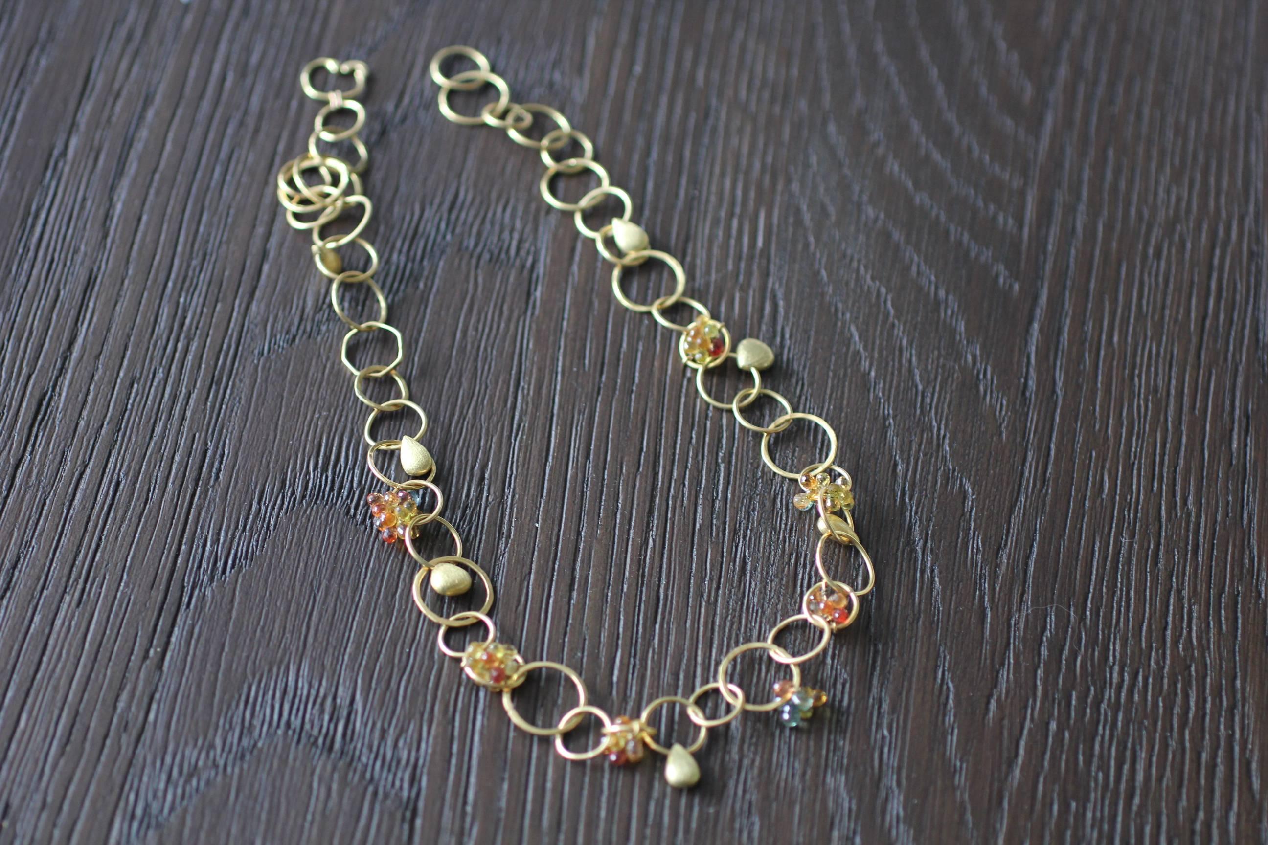 Circus Necklace is a fun link chain necklace design, light and colorful, perfect for Spring and Summer. It is made of environmentally friendly recycled 18 Karat gold. The necklace is made up of round links ranging in diameter from 10mm to 15mm, some