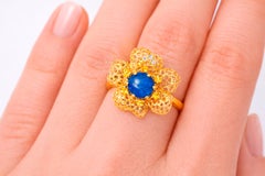 Sapphire cabochon 14k gold flower ring.