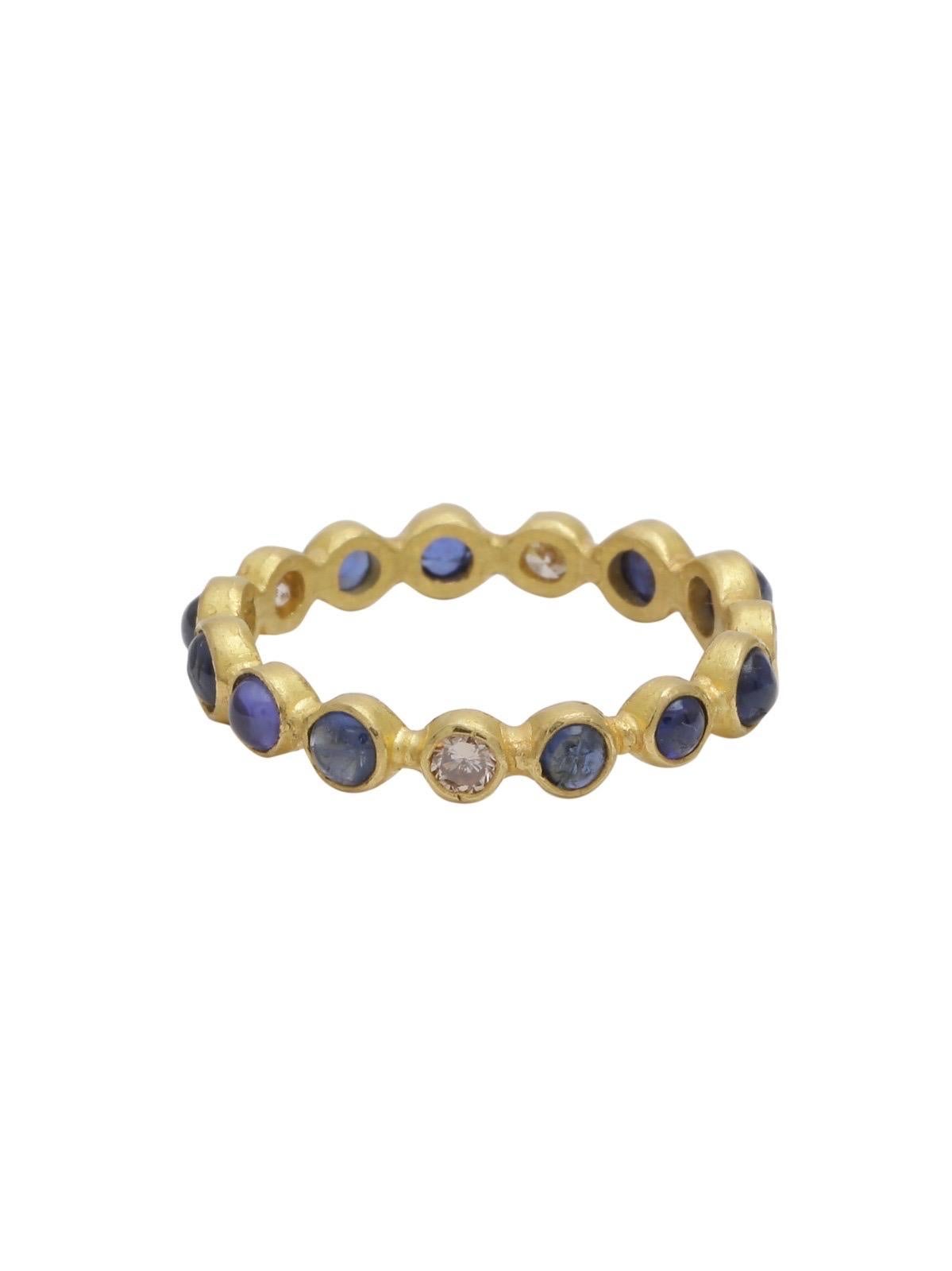 A beautiful Eternity Band made with Blue Sapphire Cabochons and White Diamonds handmade in 22k gold . 
The stackable ring can be born as is or paired with different colours or your existing bands .

The Ring has 11 vibrant sapphire cabochons