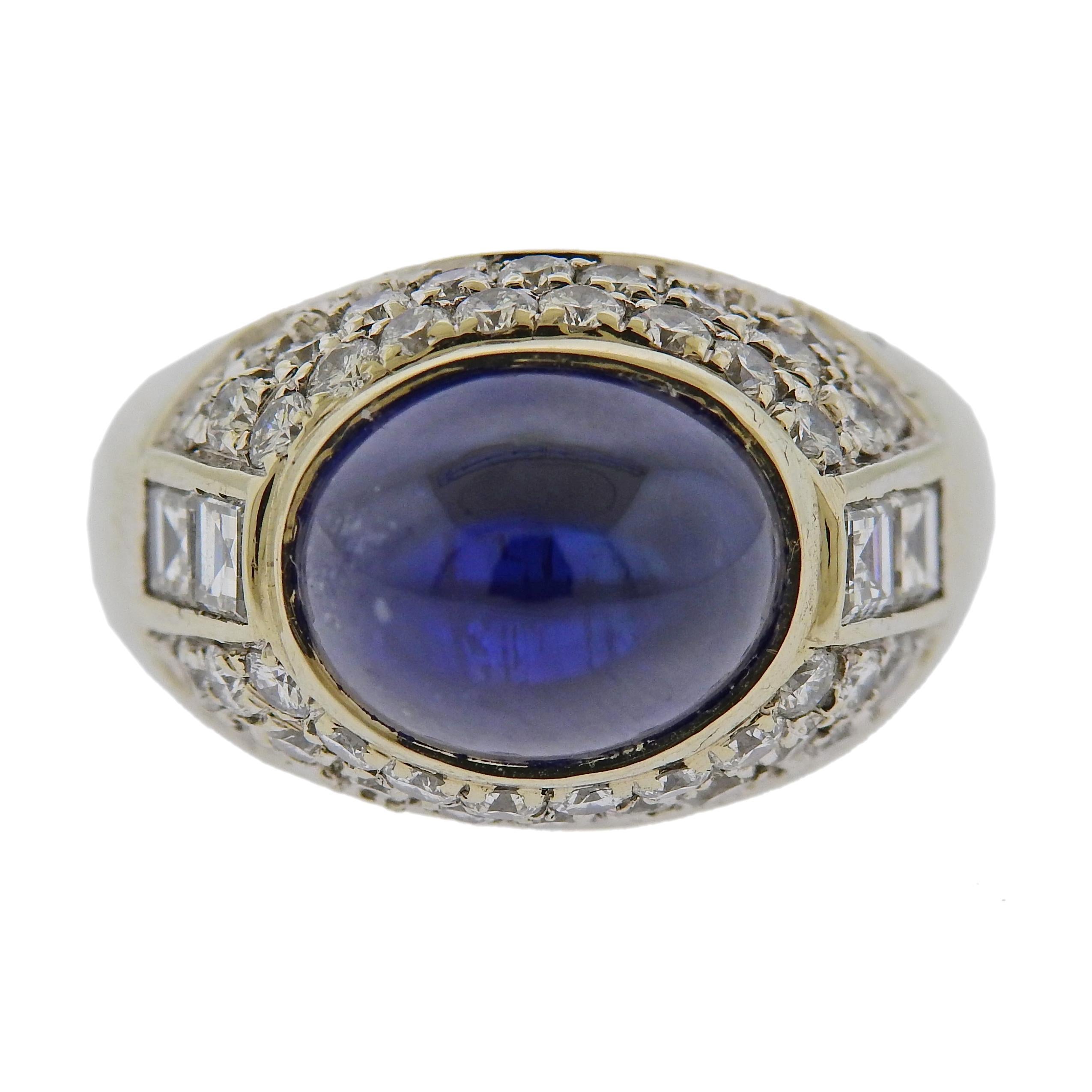 18k white gold cocktail ring, set with a 9.3mm x 11.4mm synthetic blue sapphire cabochon, surrounded with approx. 0.82ctw in diamonds. Ring size 5, ring top is 13.7mm wide, sits approx. 14mm from the top of the finger when worn. Tested 18k, weighs
