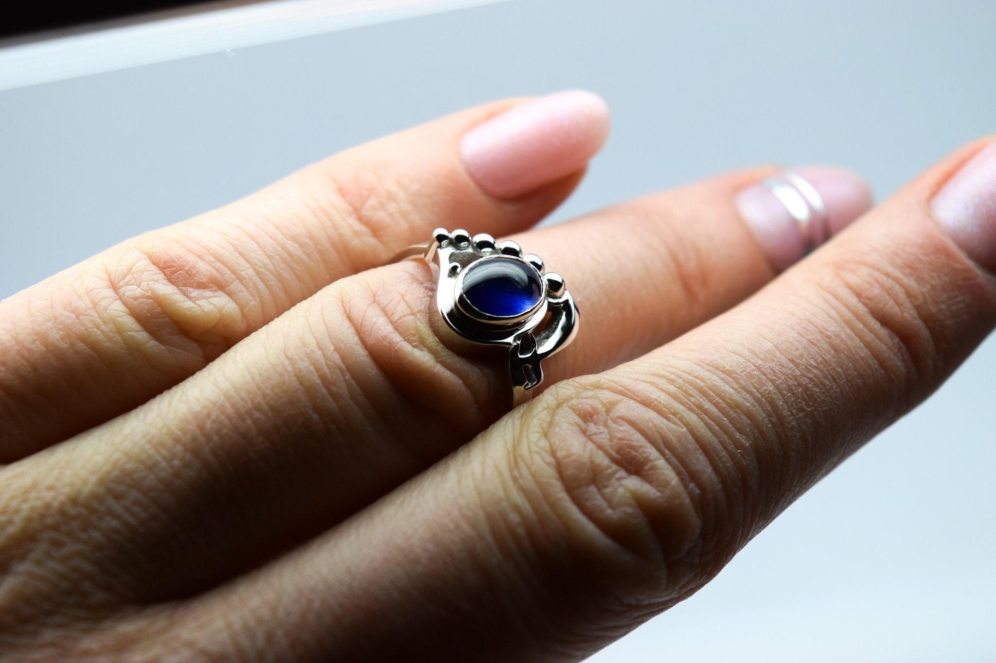 Incredible ring, so different, vintage style with art deco feel to the ring, the sapphire cabochon 2ct is a vivid blue color, stunning gemstone and fits so well with the design of the ring. Made in 18KT white gold, size 6. The ring can be re-sized