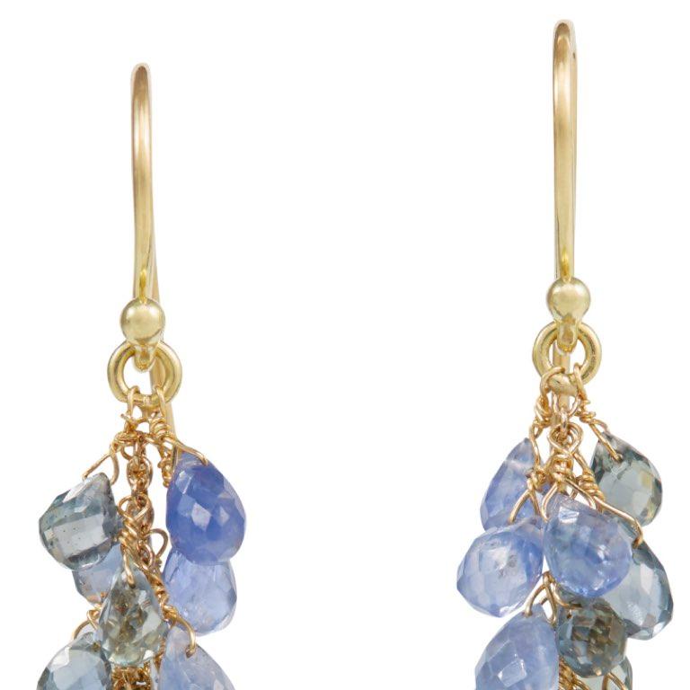 Eastern inspired cascade of tiny briolette vari-coloured blue sapphires. At the base of the earring is a blue topaz briolette. Suspended on a central wire of 18 carat yellow gold with a hook fitting at the top. Please note this item is made to order