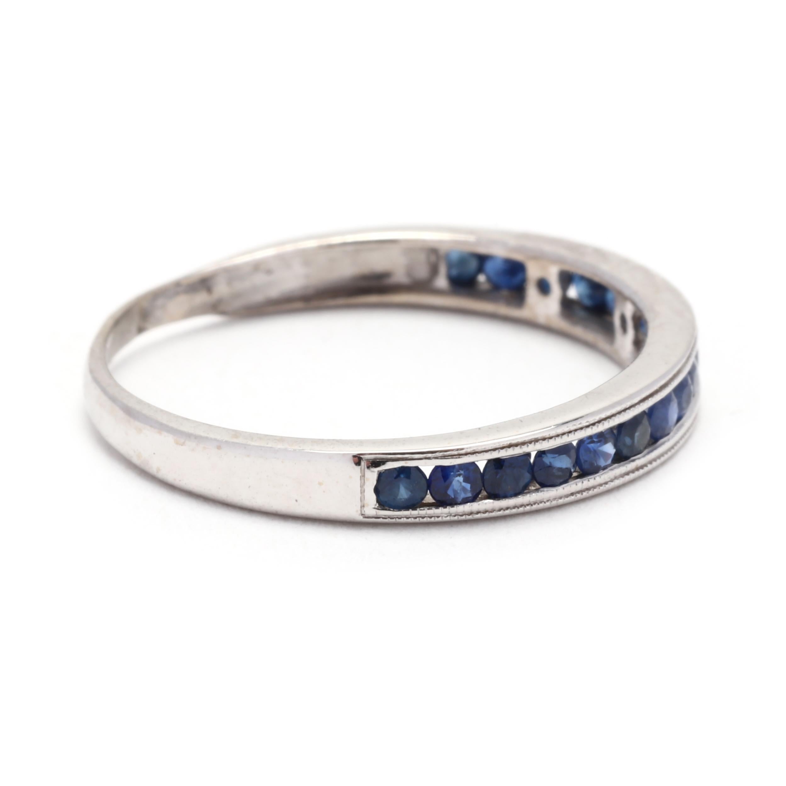 This 0.33ctw Sapphire Channel Set Milgrain Wedding Band is a stunning choice for those seeking a unique and elegant wedding band. Made from 14K white gold, this band features a series of channel-set sapphires with milgrain detailing along the edges,