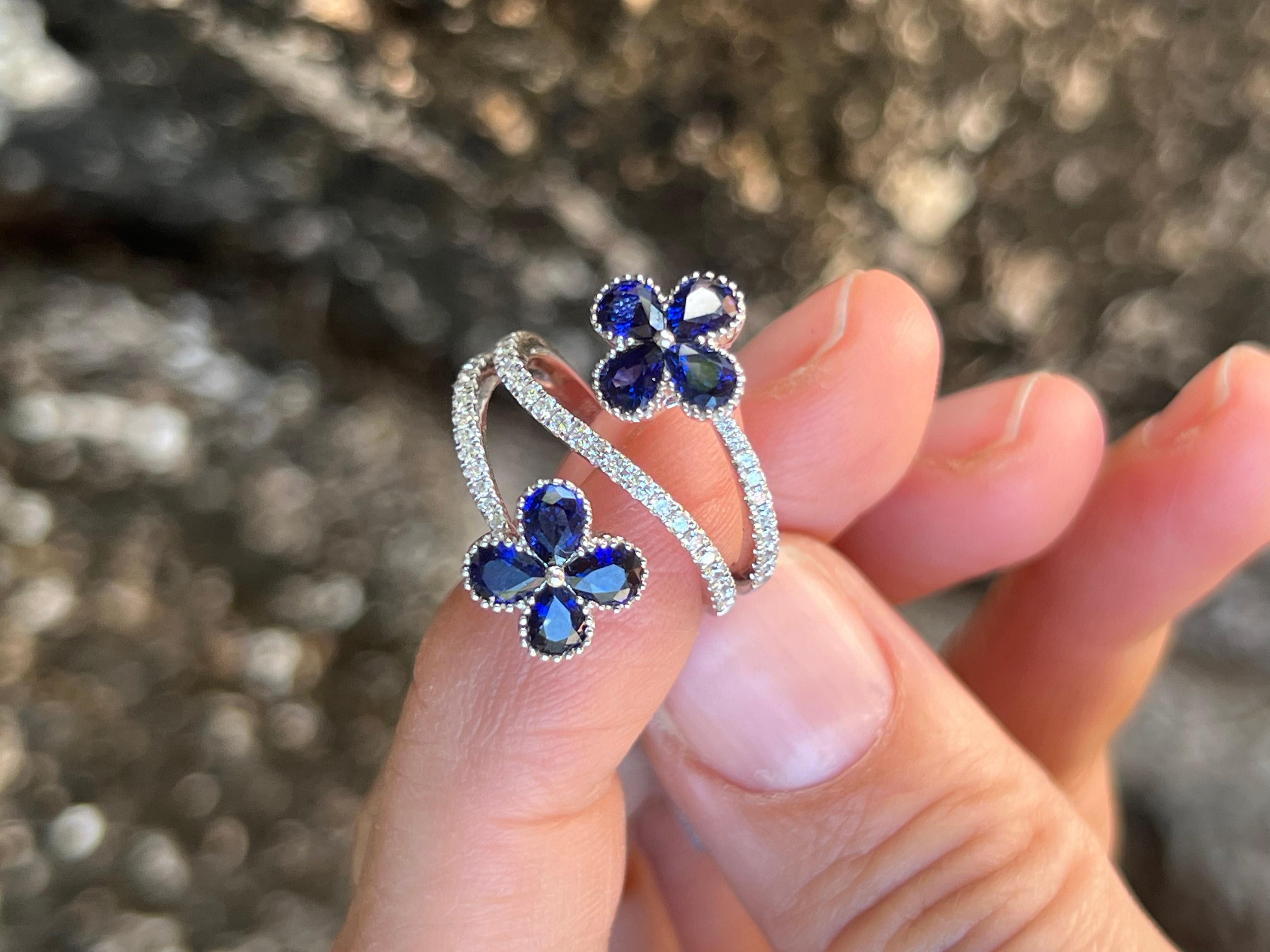 18 karat white gold with pear shaped sapphires in a clover flower shape. The diamond ring design wraps around the finger as a delicate strand around the finger 3 times, ending in the clovers.

Features
18K white gold
2.14 carat total weight in