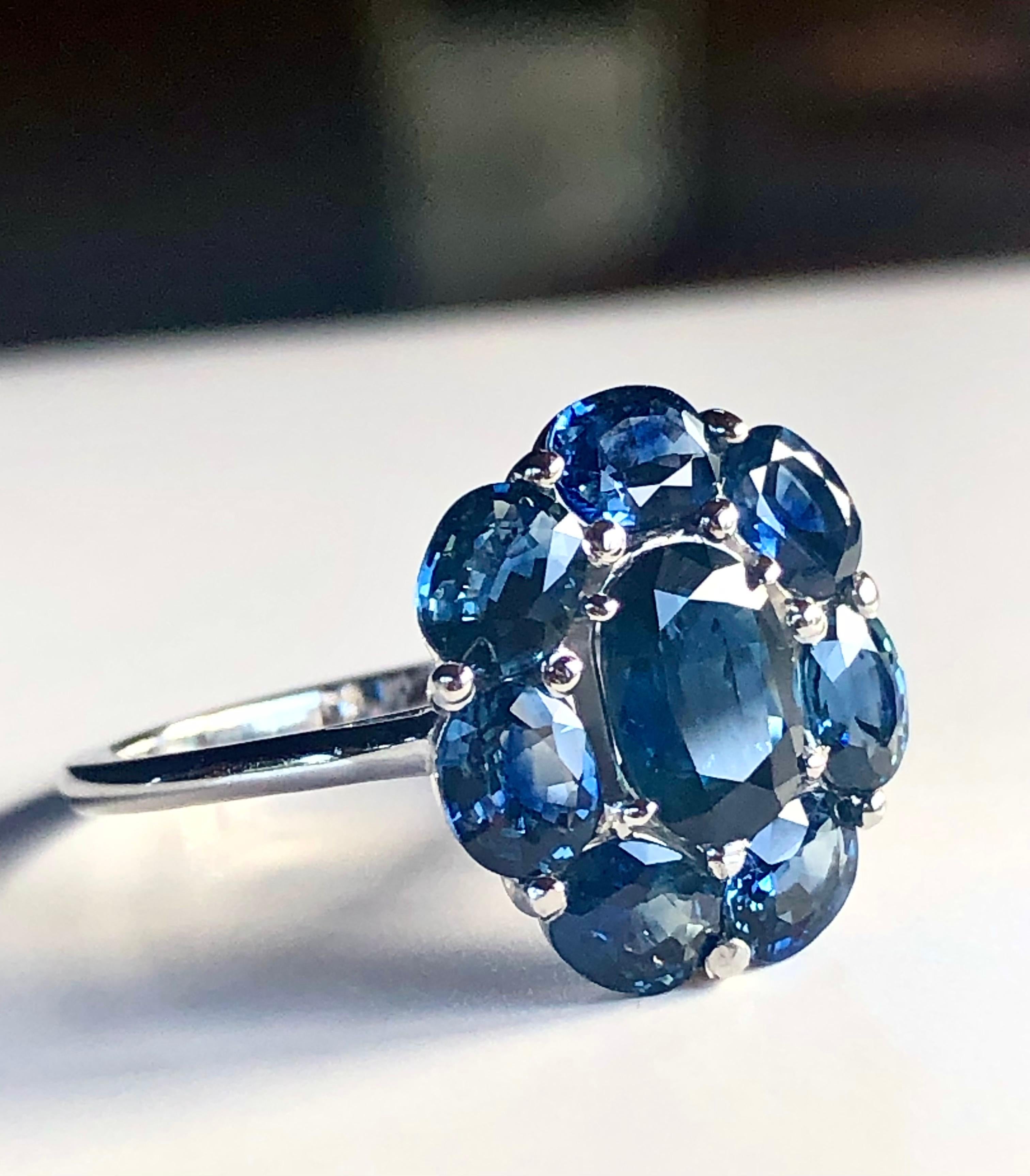A classic Emeralds Maravellous floral engagement Cocktail ring where eight Natural Royal Blue sapphires are set together, each high quality with excellent clarity and superb brilliance to create an effect of a popping blast of velvet blue color.