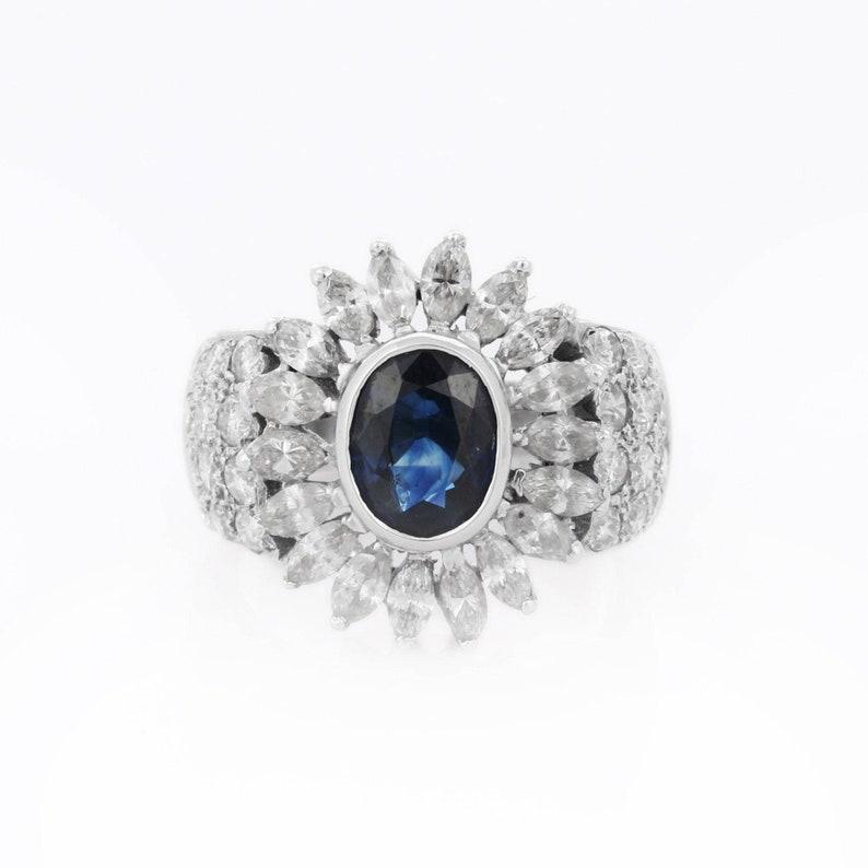 Blue Sapphire Diamond Big Flower Ring in 18K Gold featuring natural sapphire of 2.8 carats and diamonds of 2.3 carats. The gorgeous handcrafted ring goes with every style.
Sapphire stimulate concentration and reduces stress.
Designed with oval